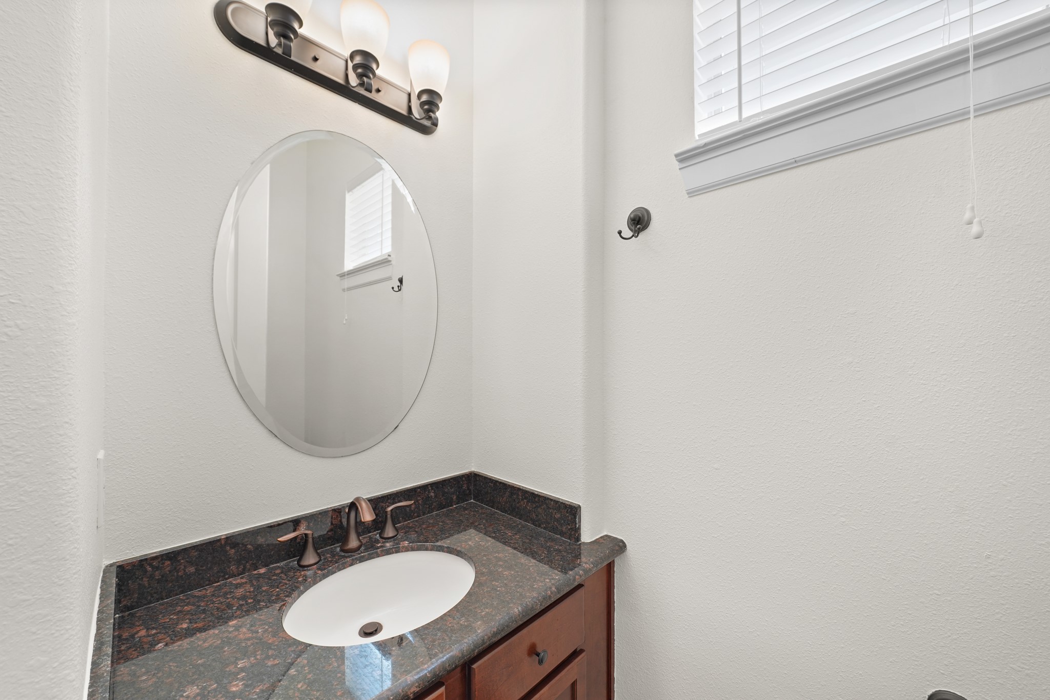Well-appointed half bathroom ideal for family, friends, and guests. It is located on the second floor.