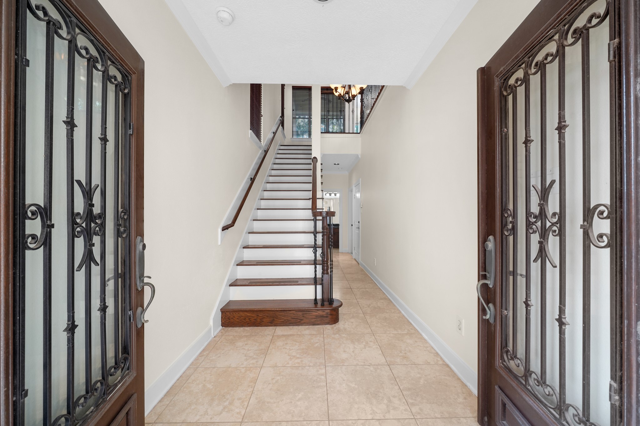You'll be instantly greeted by beautiful tile floors, and a charming stair case.