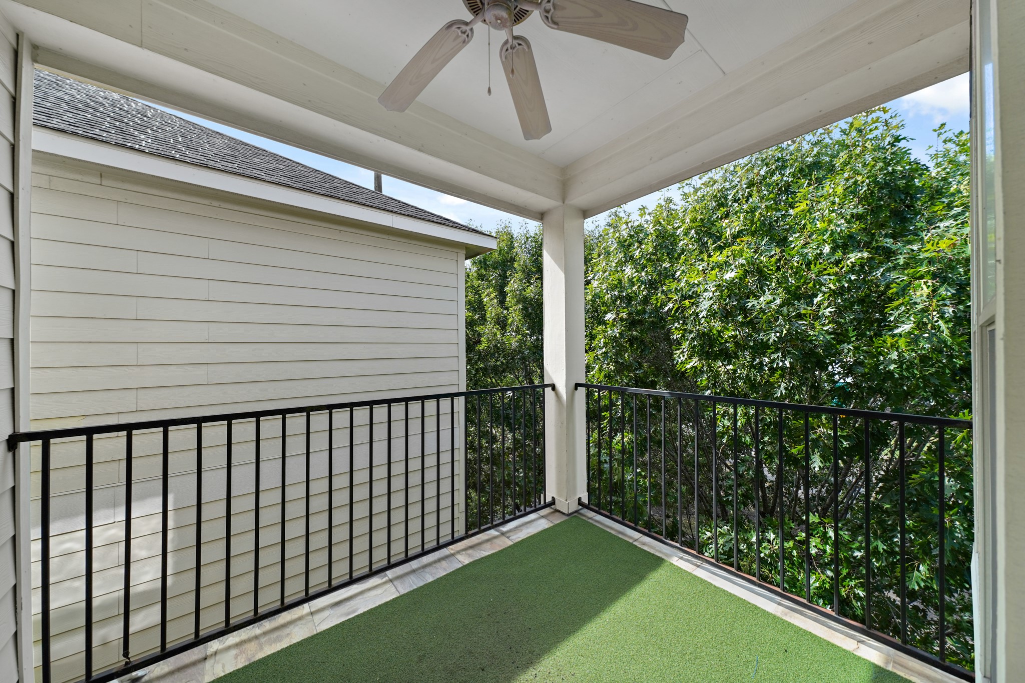 Third floor balcony just outside the primary bedroom. It also has a ceiling fan.