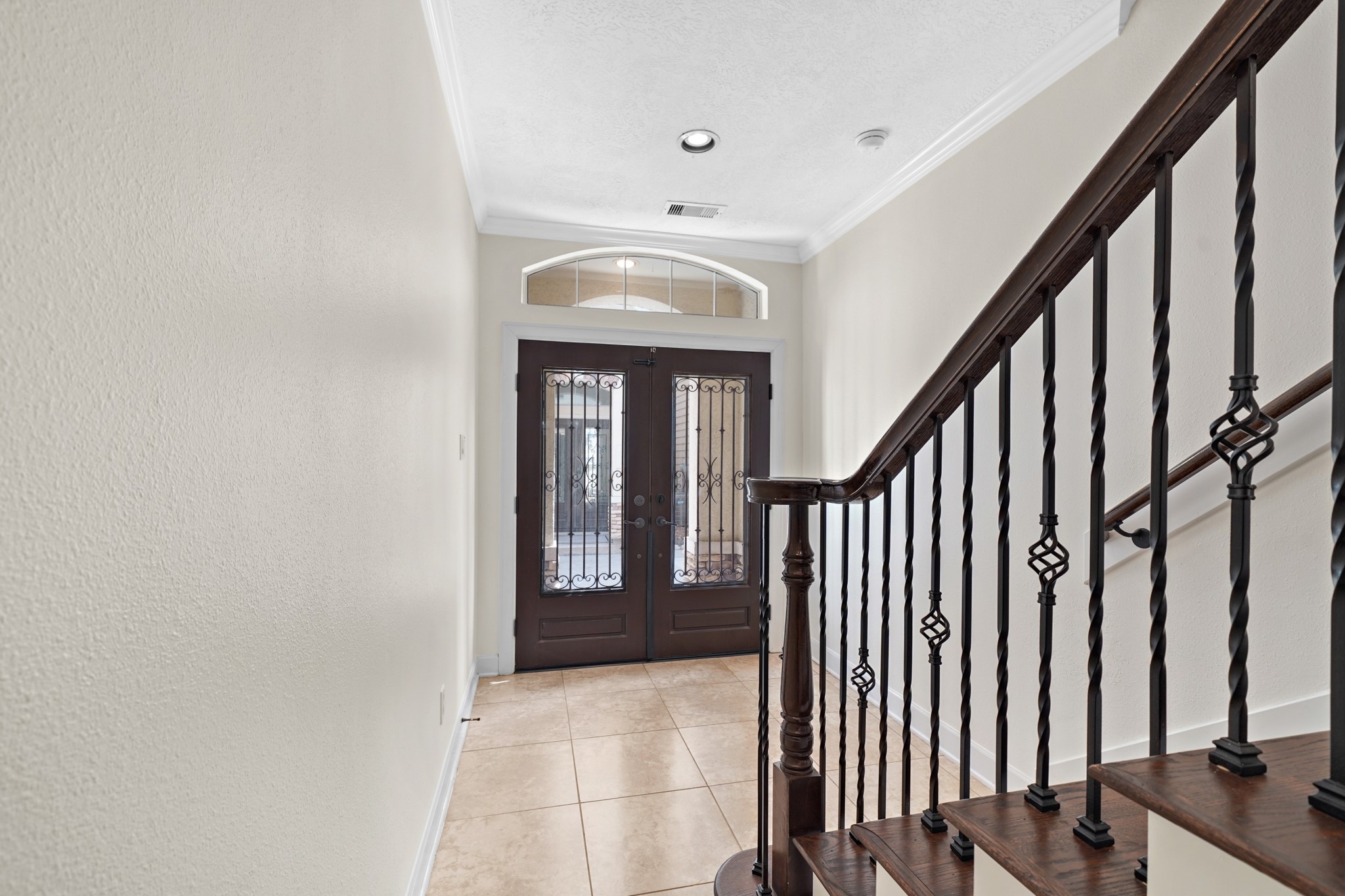 You'll be instantly greeted by beautiful tile floors, and a charming stair case.