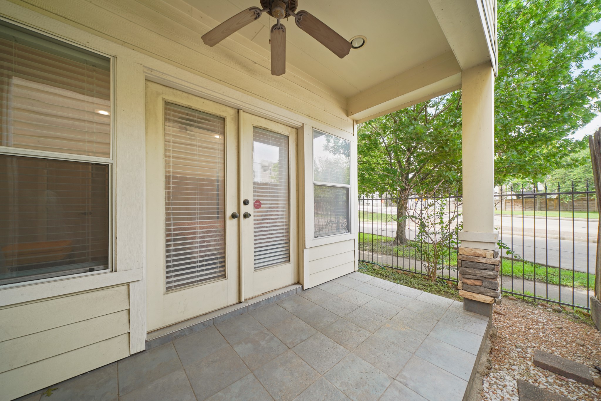 Covered patio deck with a high ceiling, a ceiling fan, recessed lighting, and great views of the neighborhood.