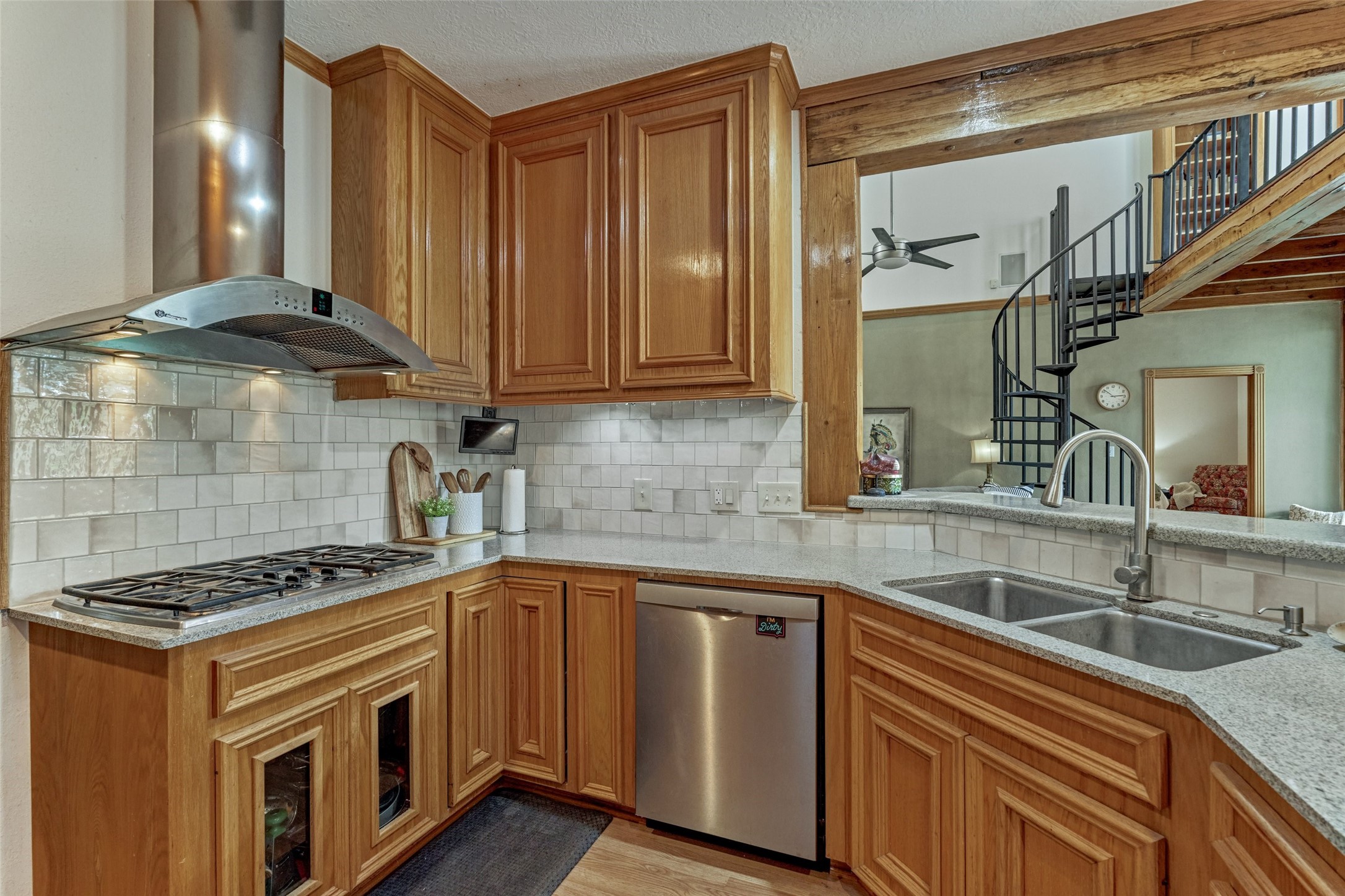 Kitchen with new zelge tile backspash open to breakfast area and living area.