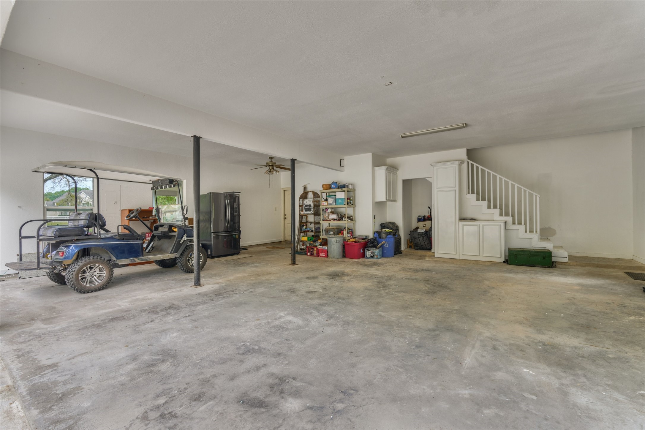 Three car garage with built-ins, staircase to upstairs flex unfinished space.