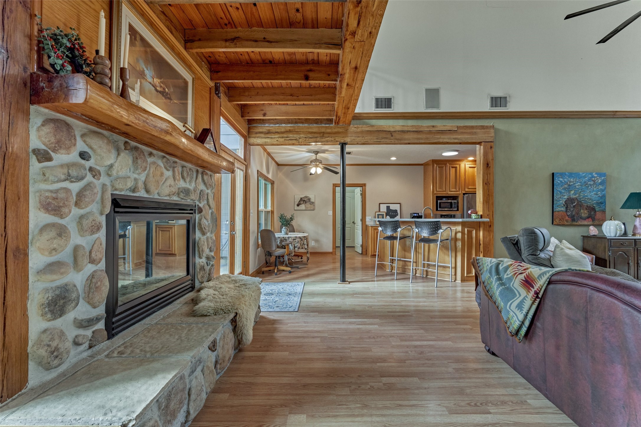 Rustic stone fireplace and custom hand hewn logs from owners original property