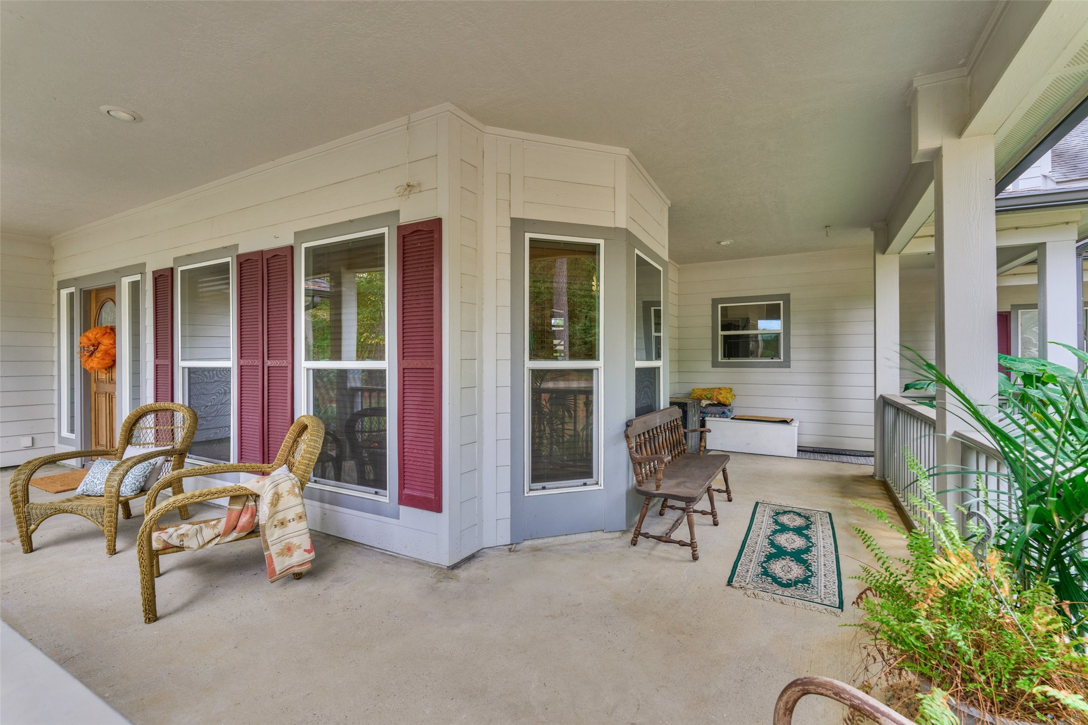 Charming wraparound porch with ample seating, perfect for relaxing and enjoying the outdoors. Charming wraparound porch with ample seating, perfect for relaxing and enjoying the outdoors.