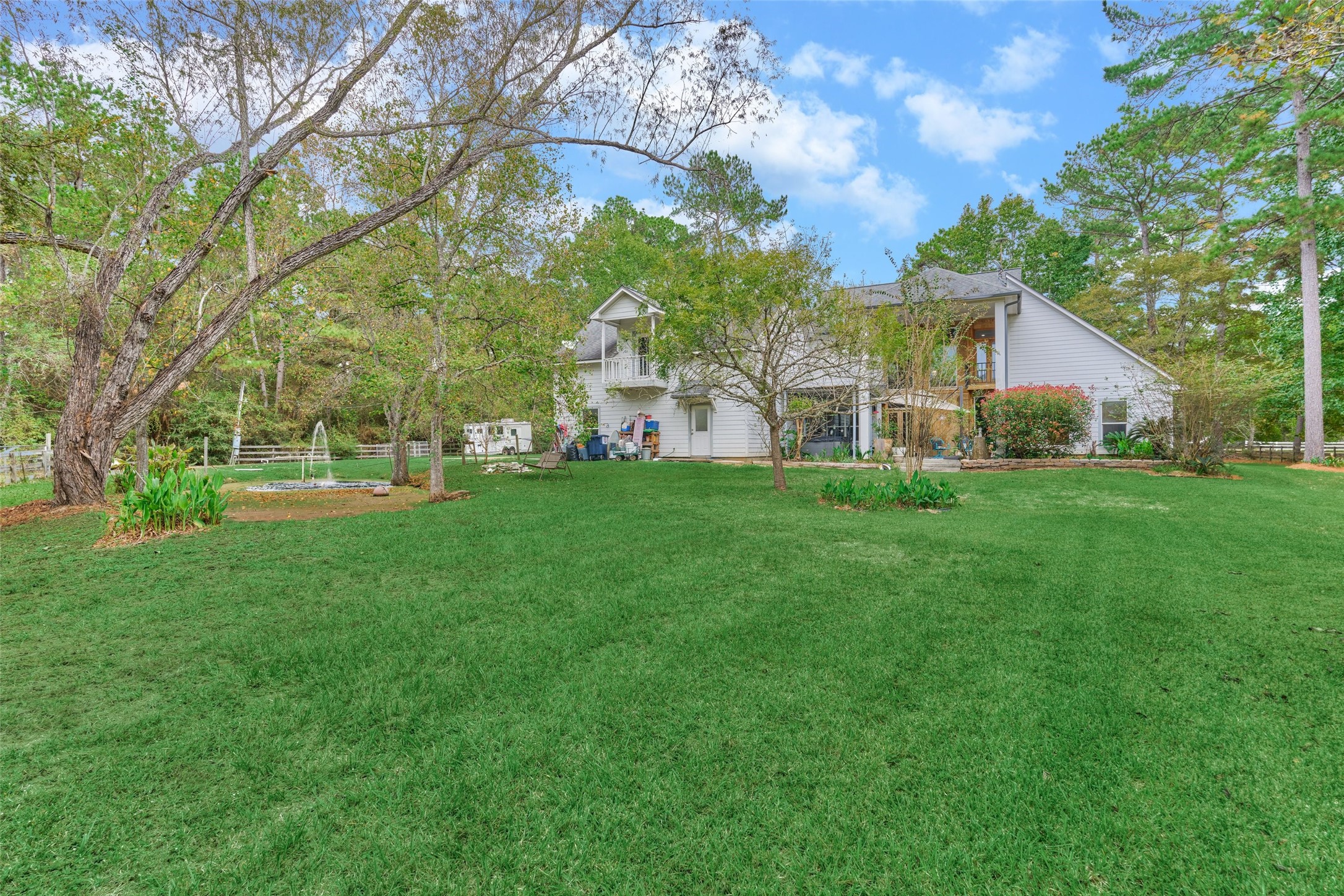 View of back of home/pond/pastures