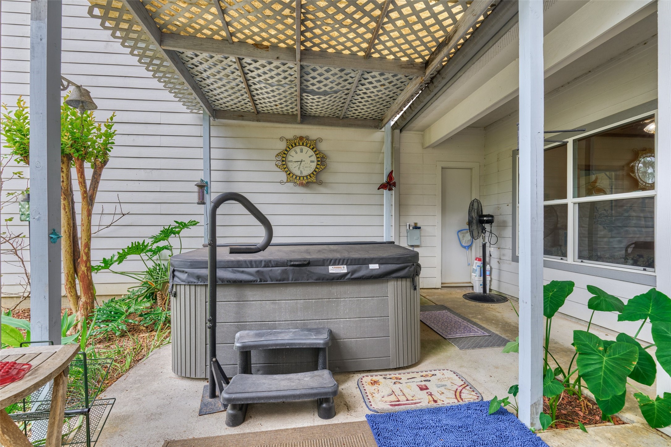Hot tub on covered back patio is available as a non-realty item or can be removed.  Access to half bath/shower from porch.