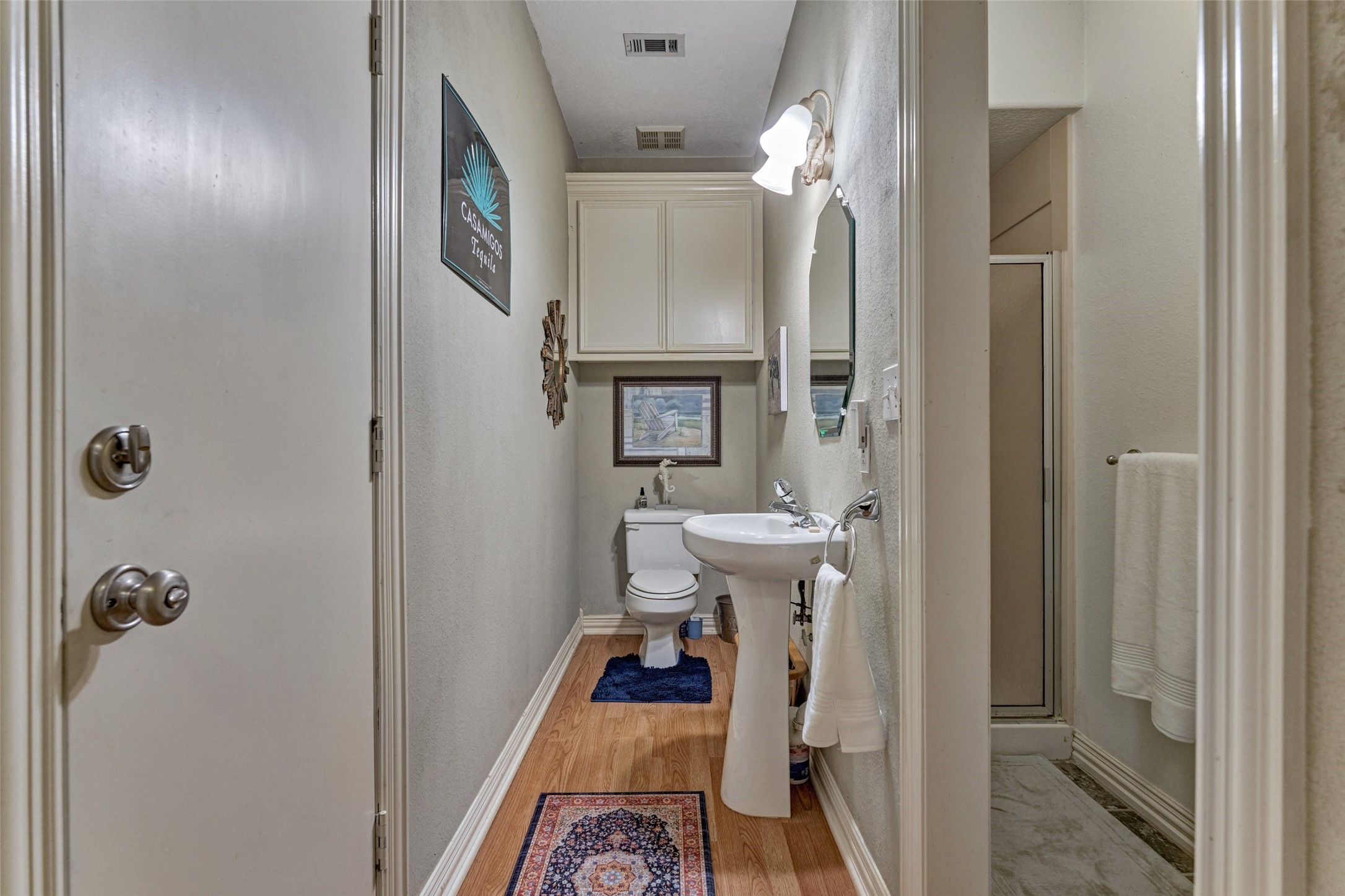Half bath with shower, entrance from back patio and also from garage and utility room.