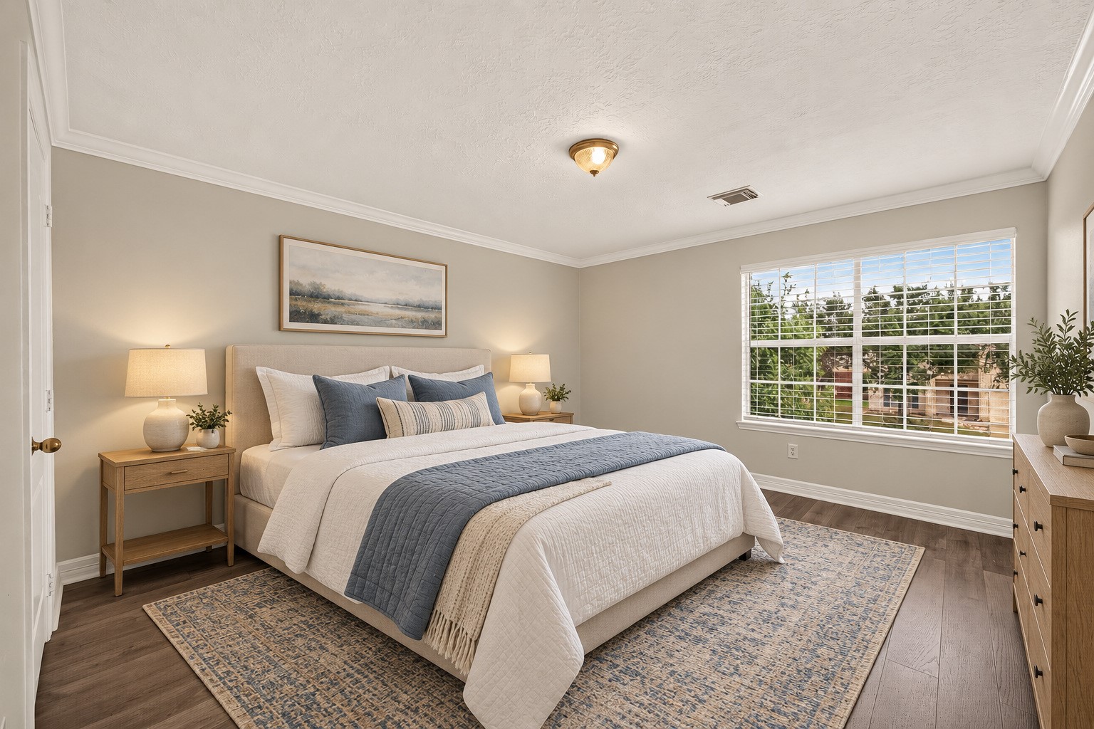 The third guest bedroom with a large window, crown molding, and vinyl flooring. Virtually staged.