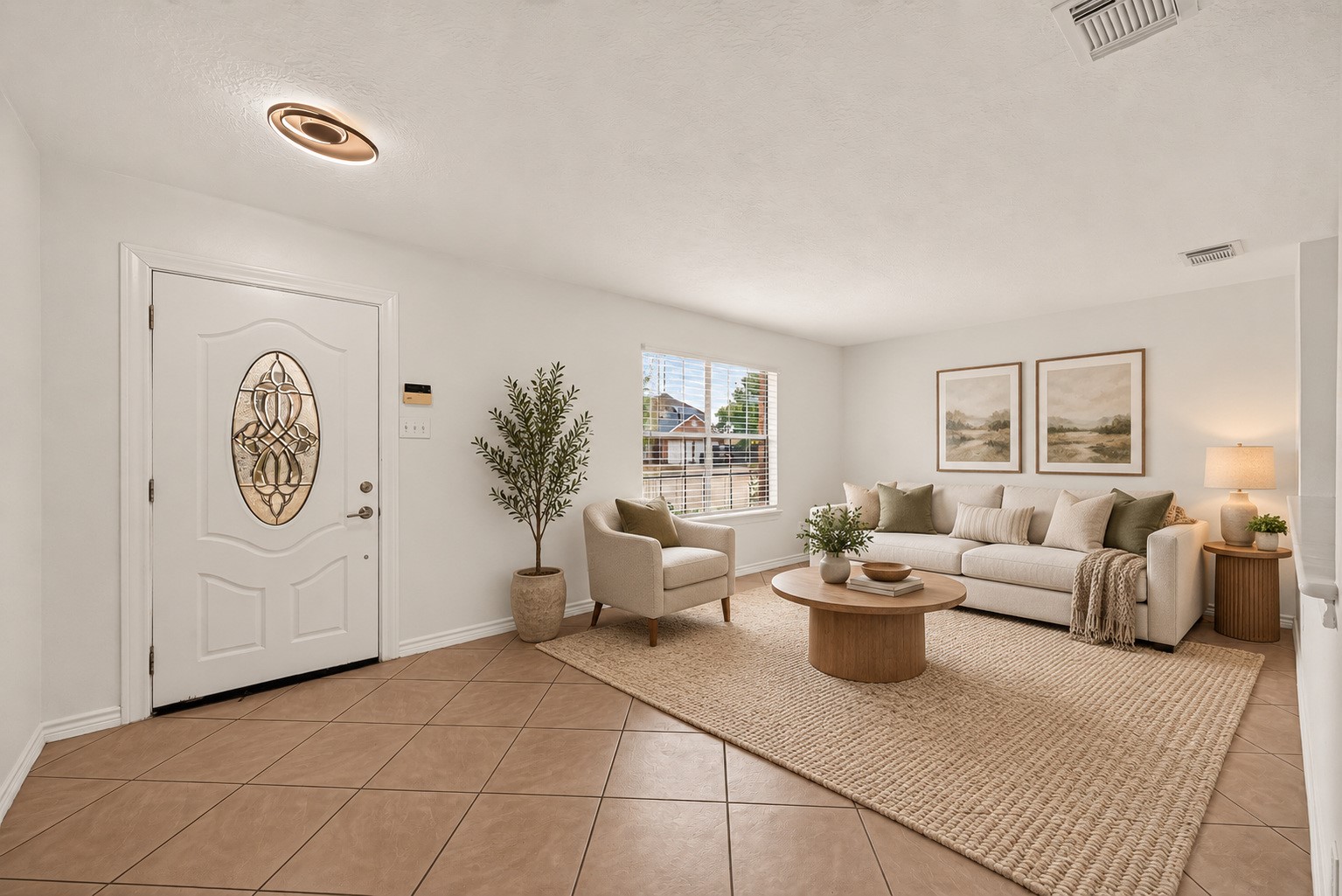 Bright living room with space to relax and welcome guests. Virtually staged.