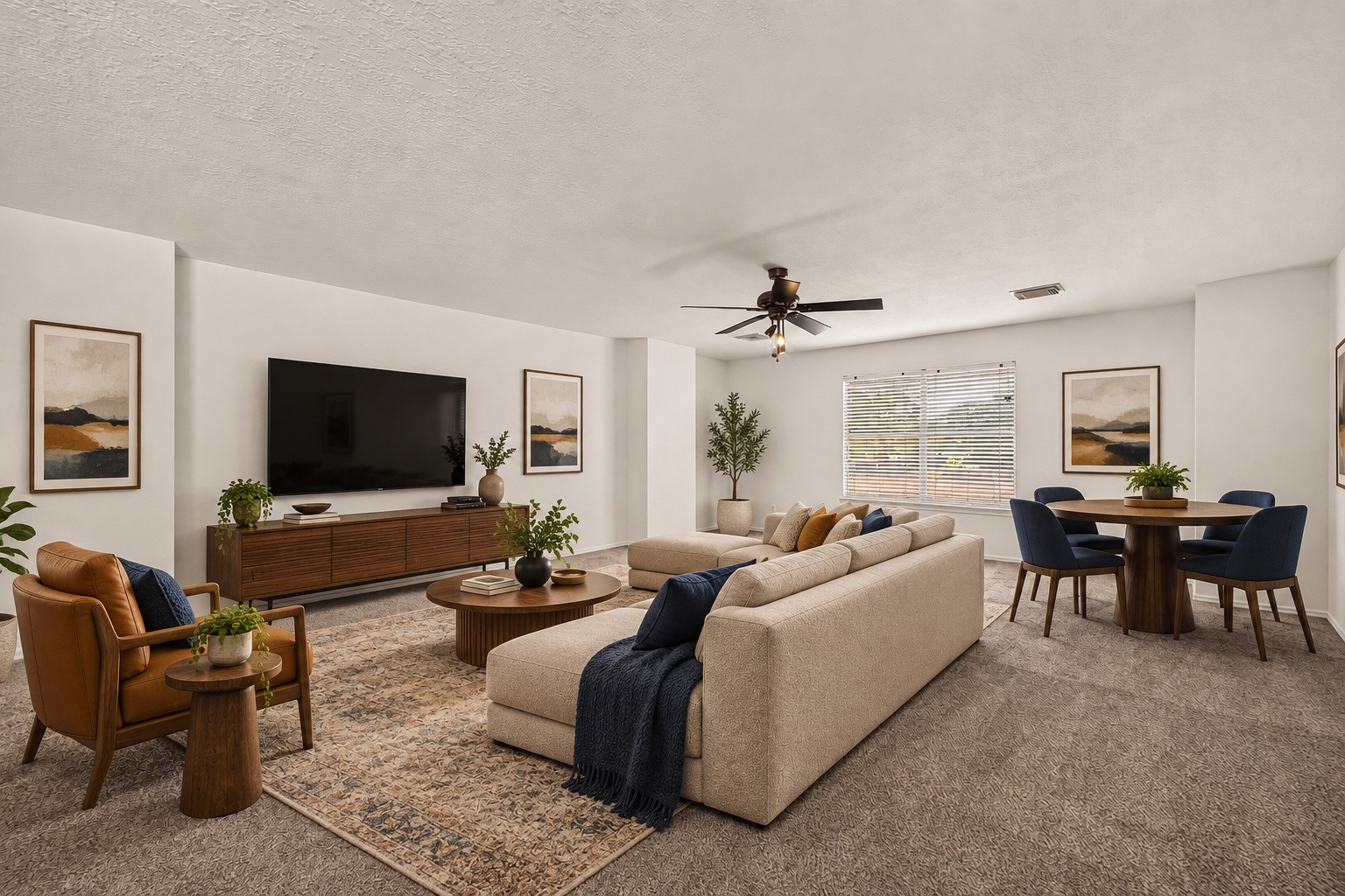 Spacious upstairs game room with a ceiling fan and window. Virtually staged.
