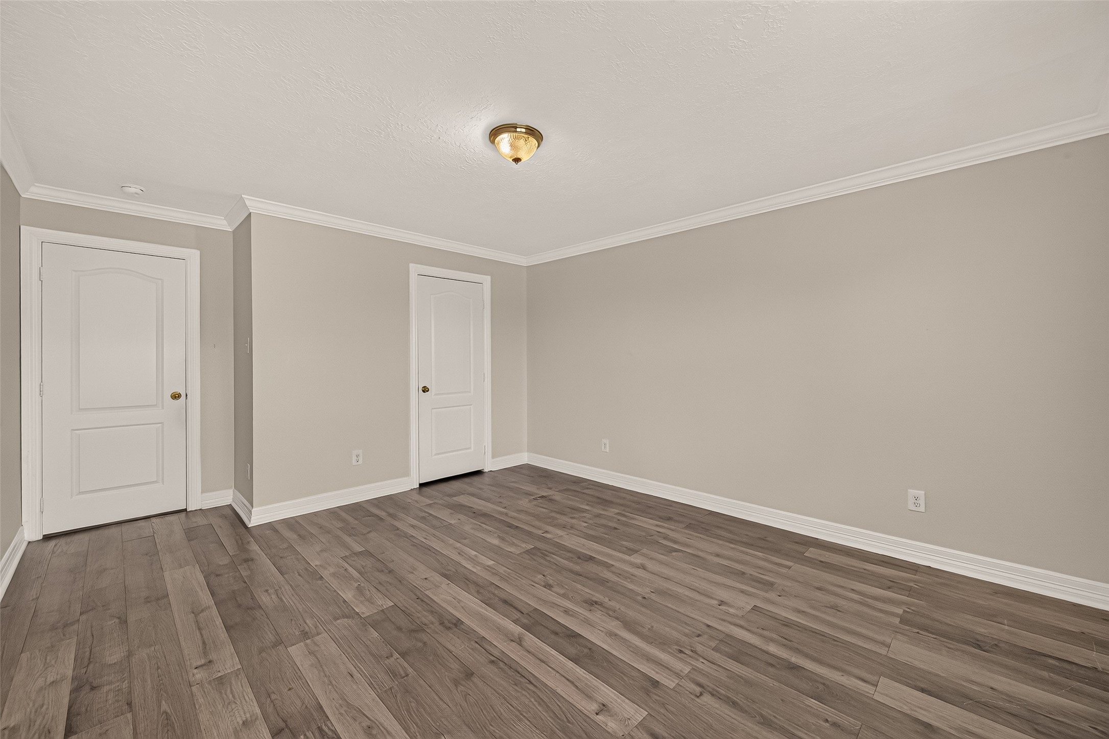The third guest bedroom offers plenty of space to make it your own, with vinyl flooring, crown molding, and a broad wall ready for your furniture.