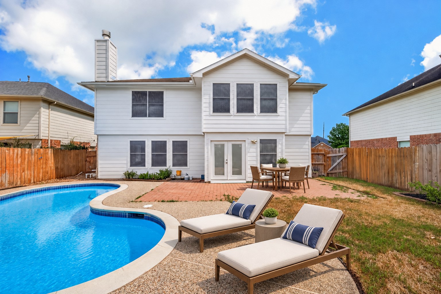 Your own backyard escape: cool off in the private pool, then relax on the patio with room to entertain. Virtually staged.