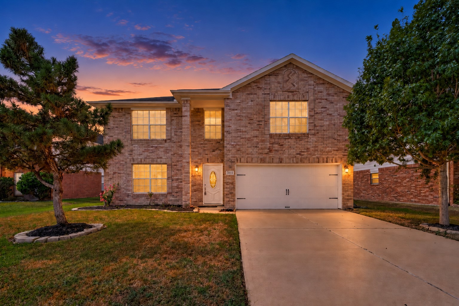 Mature trees and established landscaping add to the inviting curb appeal of this home zoned to Katy ISD.
