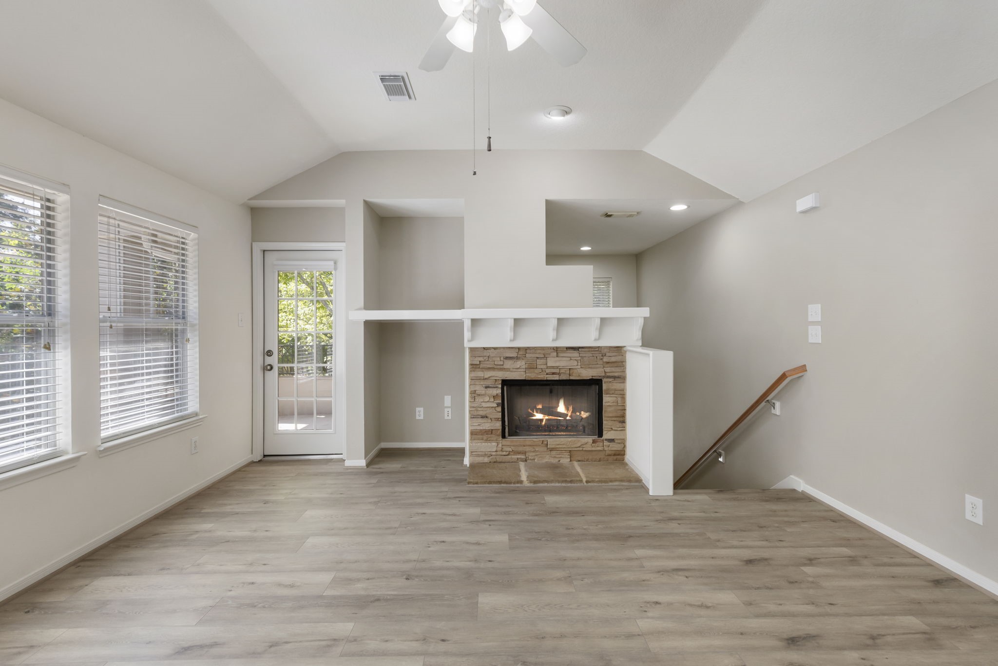 Stone gas log fireplace is a focal point.