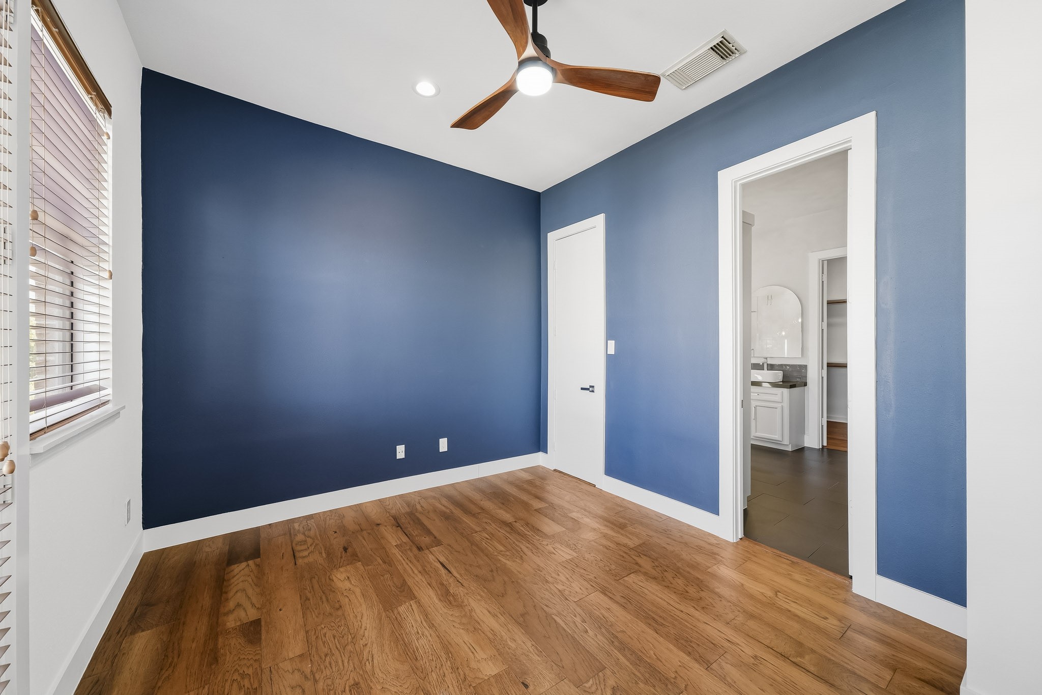 This beautifully appointed secondary bedroom has a walk-in closet and is attached to the primary bathroom.