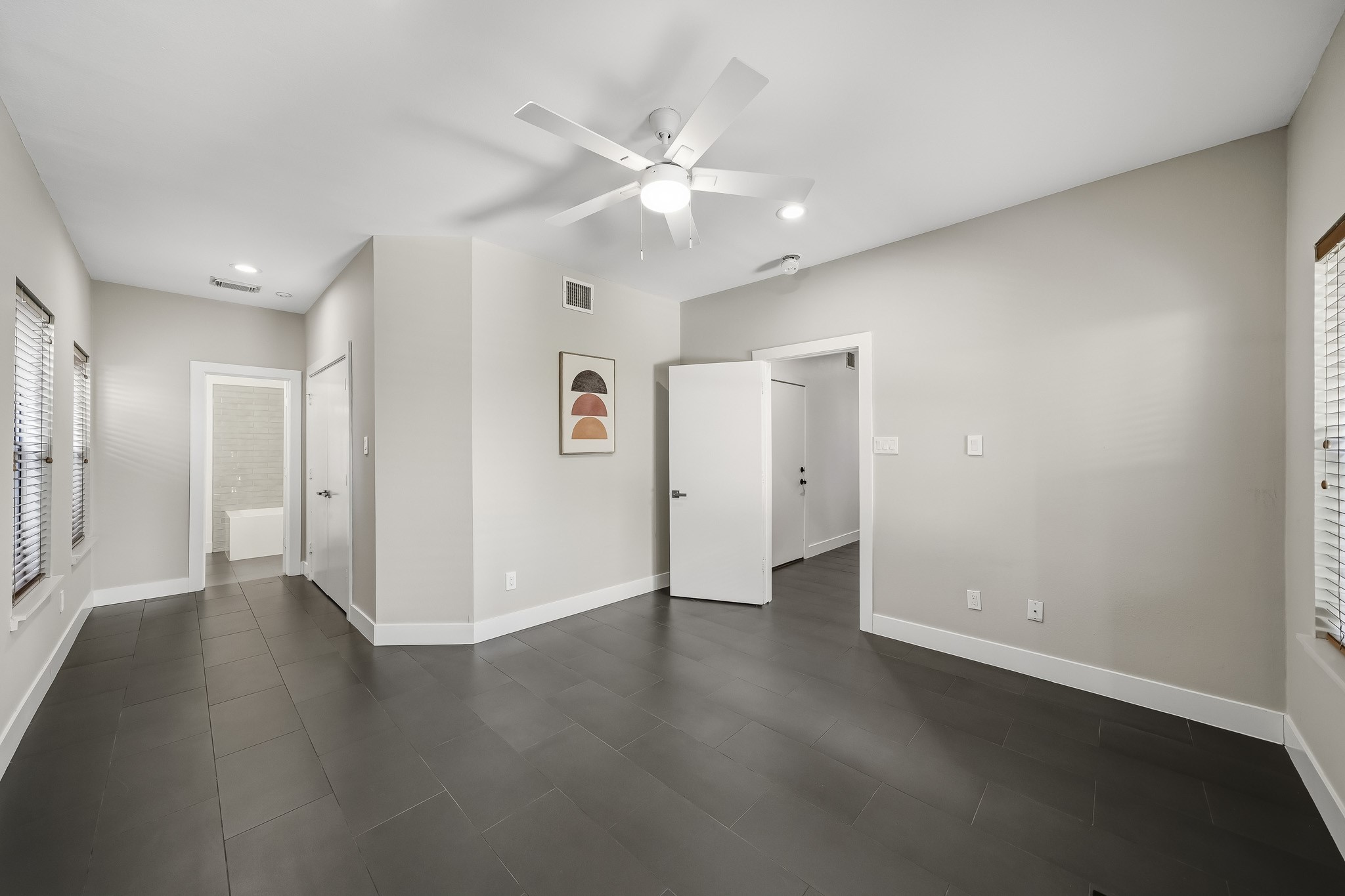 Featuring double doors that open to a spacious closet and the convenience of an ensuite bath, this versatile room offers the flexibility to suit your lifestyle, whether used as a guest suite, home office, or additional bedroom.
