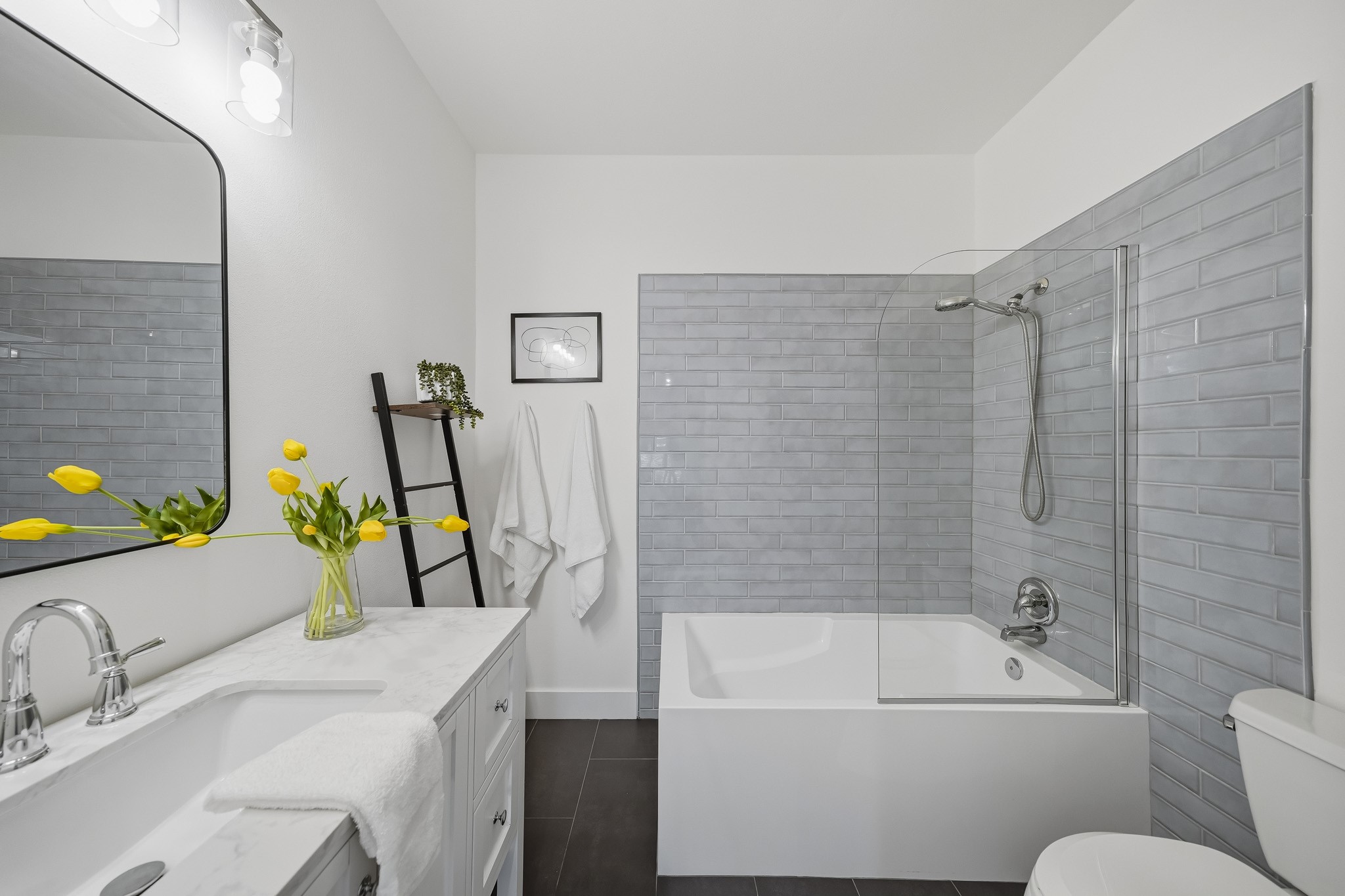 The soaking tub and shower combination features a classic subway tile surround, creating a clean, sophisticated look.