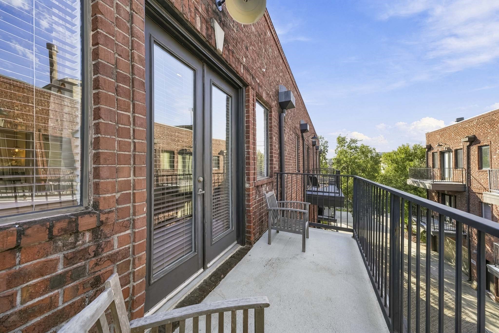 French doors from the primary suite open to a private third-floor balcony, offering an elevated outdoor escape perfect for enjoying morning coffee, taking in the fresh air or relaxing beneath the evening sky.