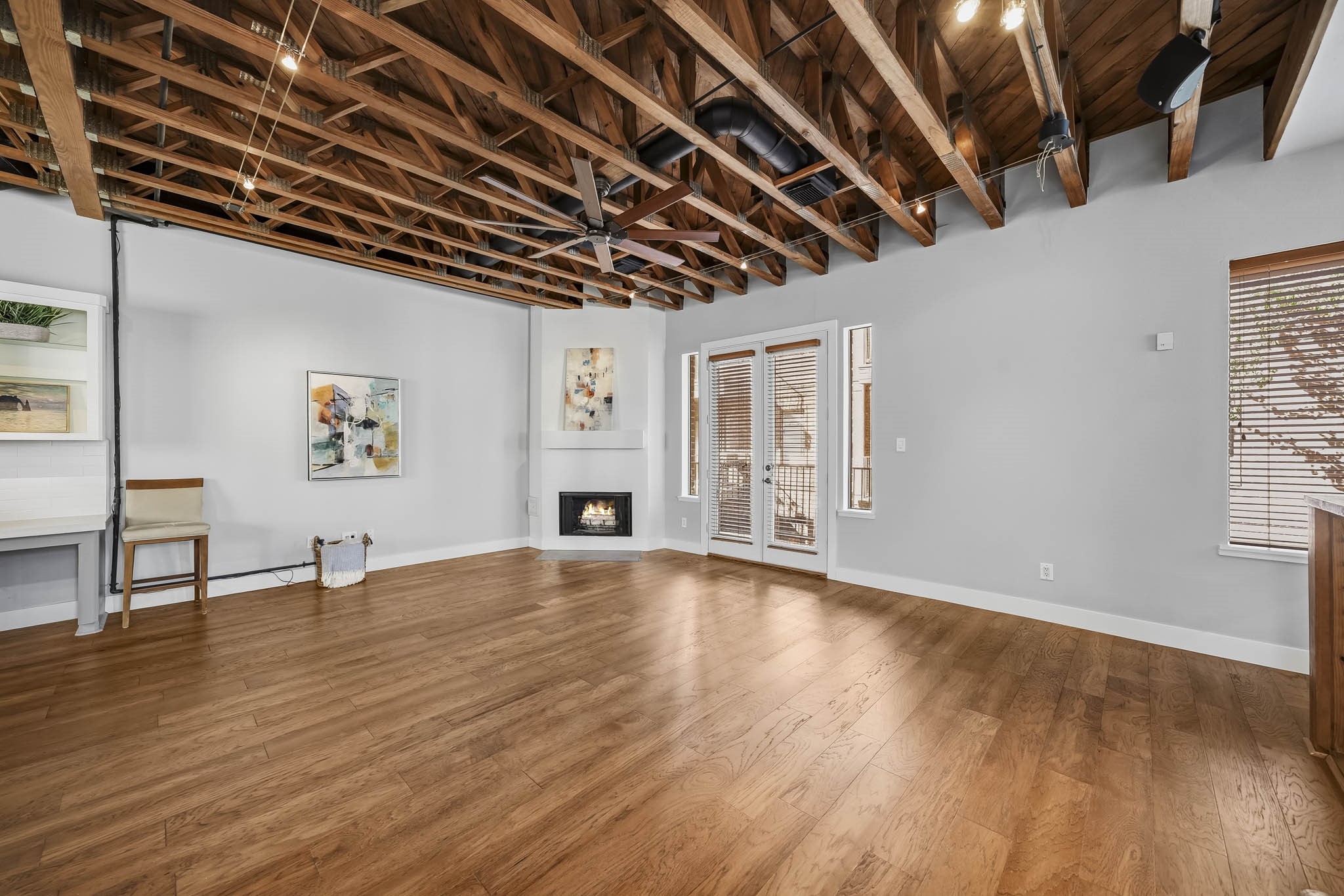 Elegant eight-foot French doors extend the family room onto a covered balcony, creating a seamless connection between indoor and outdoor living.
