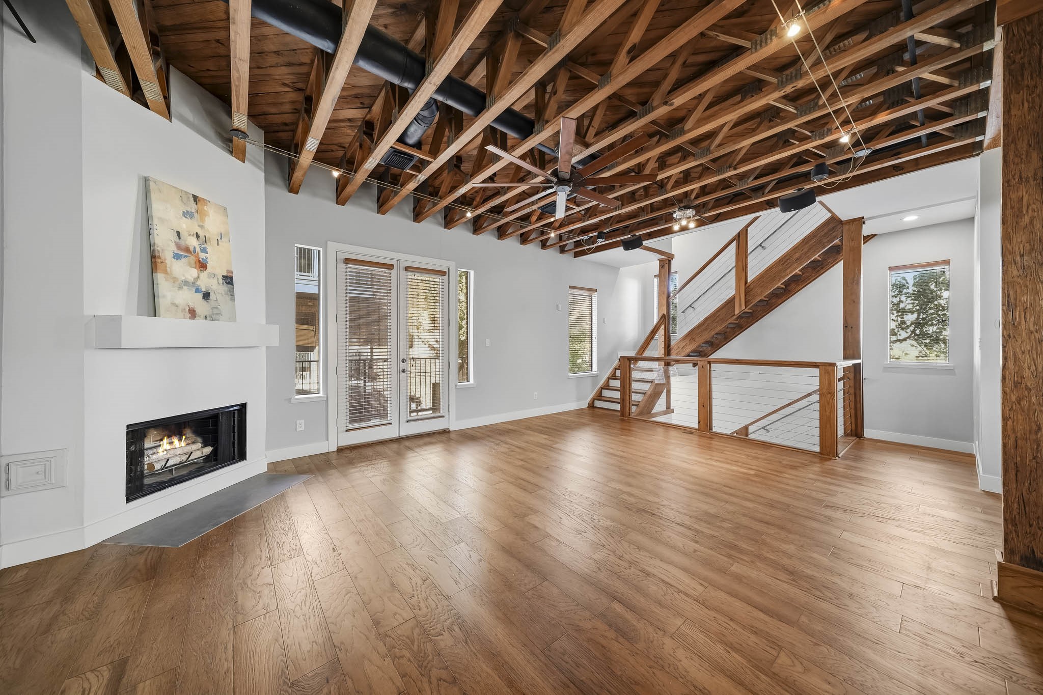 The open staircase ascends gracefully to the third level, creating a sense of spaciousness and architectural continuity throughout the home.