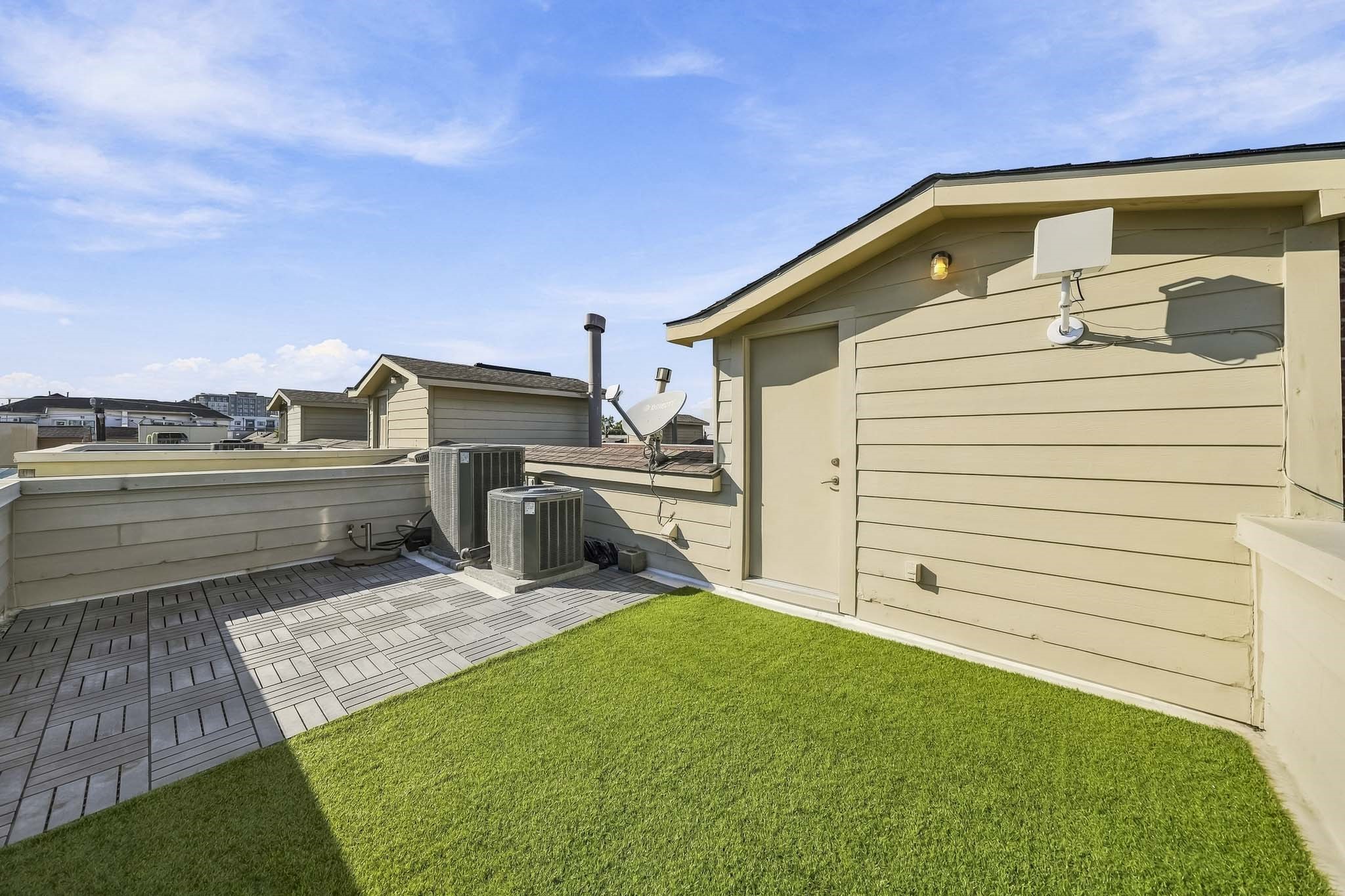 Another view of the expansive 21 x 13 rooftop terrace, where low-maintenance artificial turf and sweeping 180-degree views of the Downtown Houston skyline create an extraordinary outdoor escape above the city.