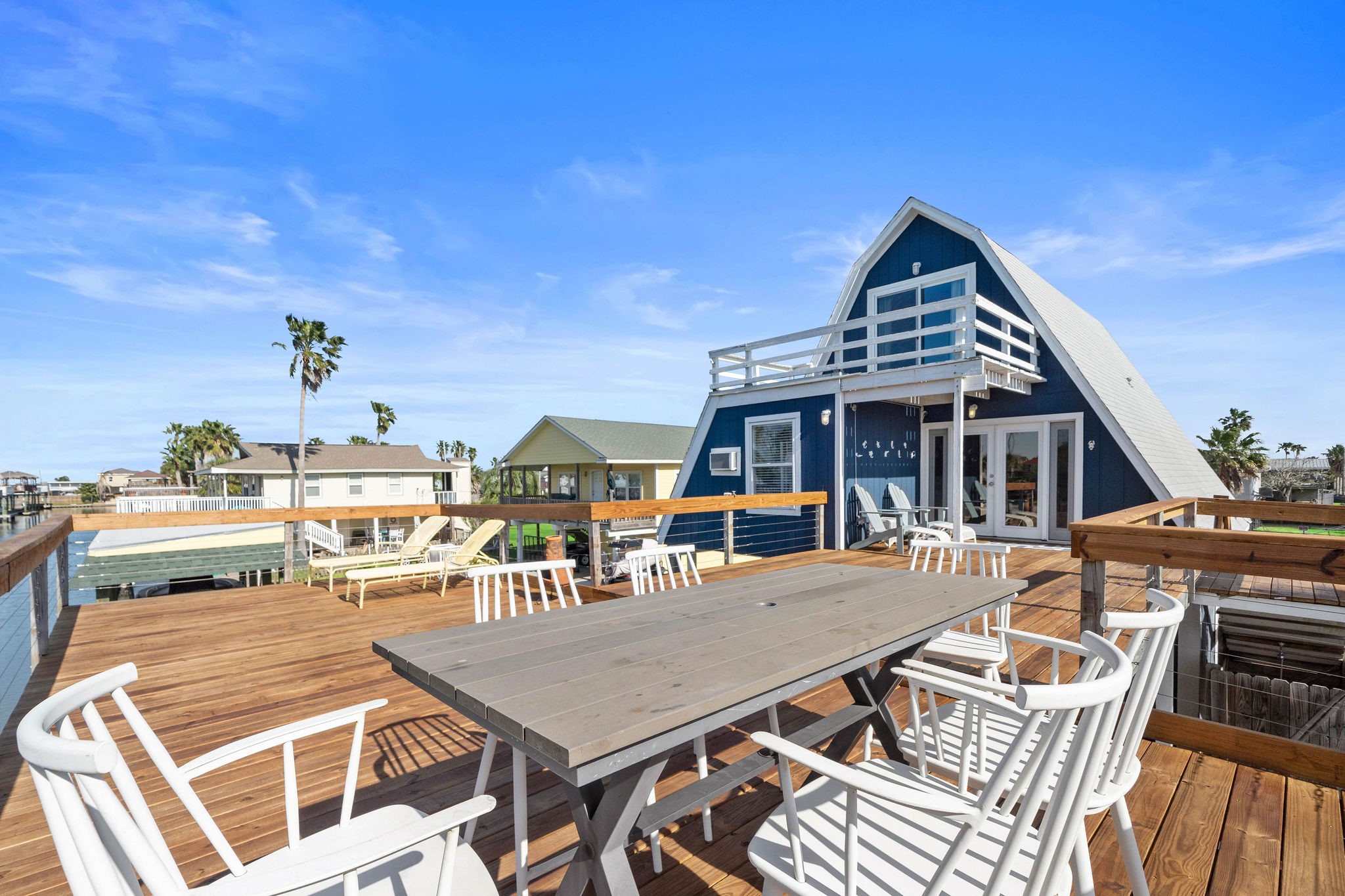 Charming A-frame home with a spacious wooden deck, perfect for outdoor dining and relaxation, offering stunning views and a serene atmosphere. Charming A-frame home with a spacious wooden deck, perfect for outdoor dining and relaxation, offering stunning views and a serene atmosphere.
