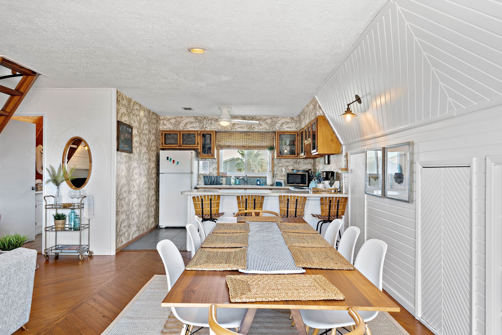 Open-concept dining area with a rustic kitchen featuring wood cabinetry and vintage charm, perfect for entertaining.