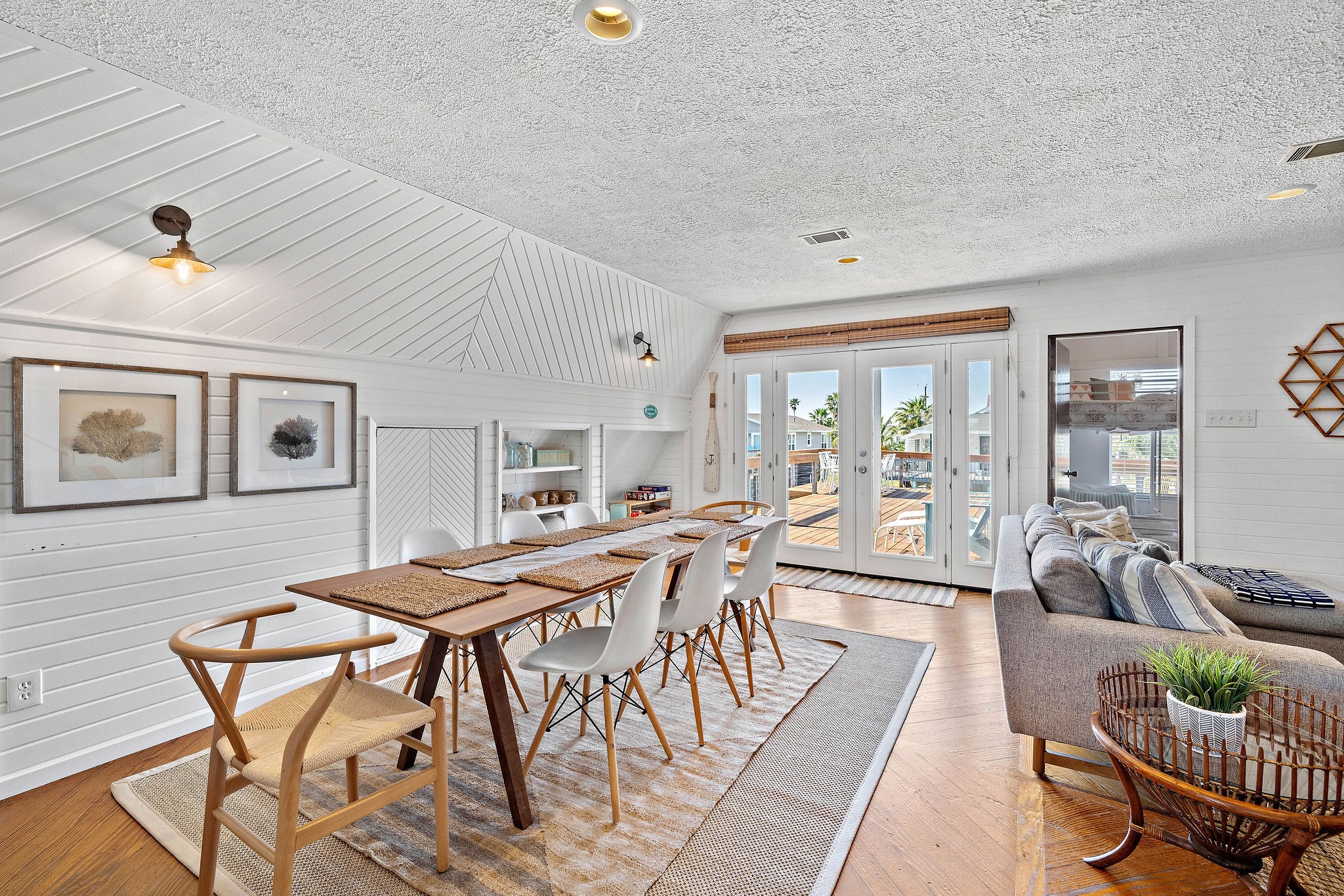 Bright and inviting dining area with stylish wood accents, a large table for gatherings, and French doors leading to a sunlit deck. Bright and inviting dining area with stylish wood accents, a large table for gatherings, and French doors leading to a sunlit deck.