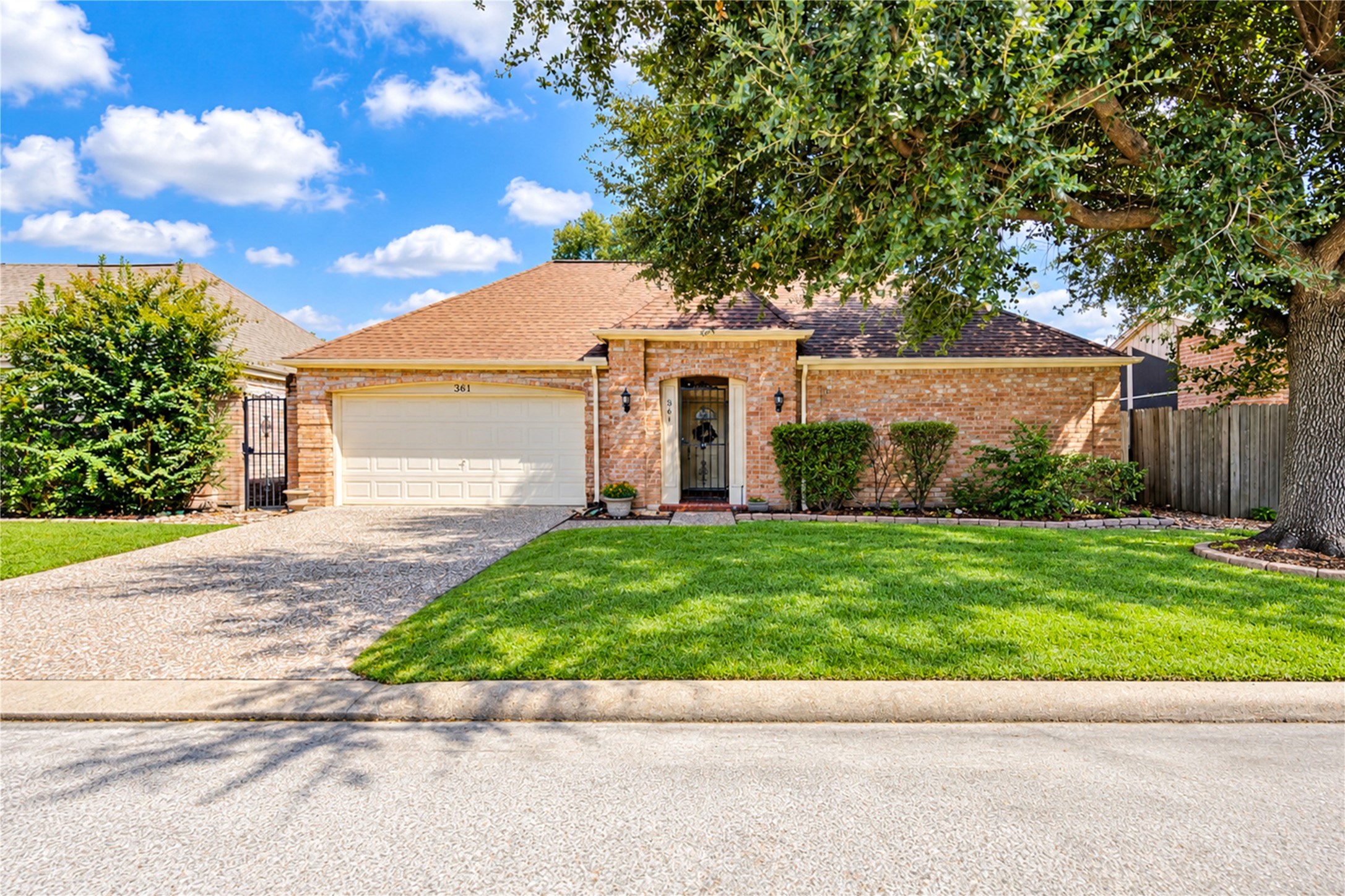 Charming brick home with a welcoming front entrance, neatly landscaped yard, and a spacious two-car garage, all nestled in a fabulous Golf Course community.