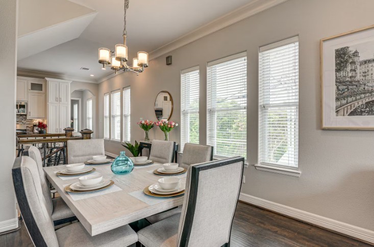 Elegantly appointed dining area, bathed in natural light, with stylish furnishings included.