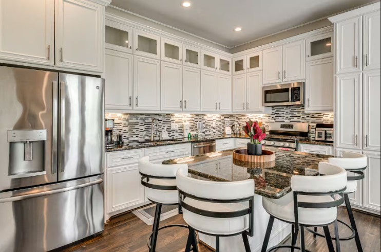 Elegant and fully furnished kitchen with modern stainless steel appliances, sleek cabinetry, and a stylish island for gatherings. Elegant and fully furnished kitchen with modern stainless steel appliances, sleek cabinetry, and a stylish island for gatherings.