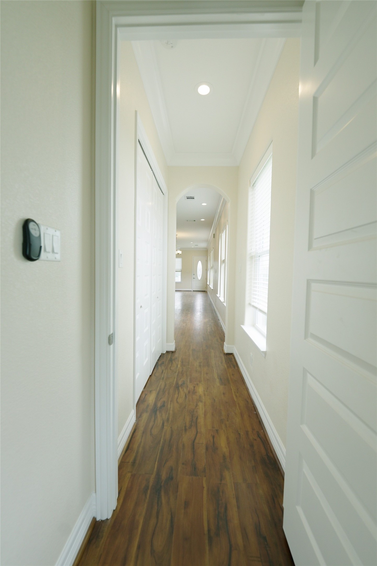 Guest bedroom features elegant hardwood floors leading to an inviting kitchen and living area. Currently tenant occupied.