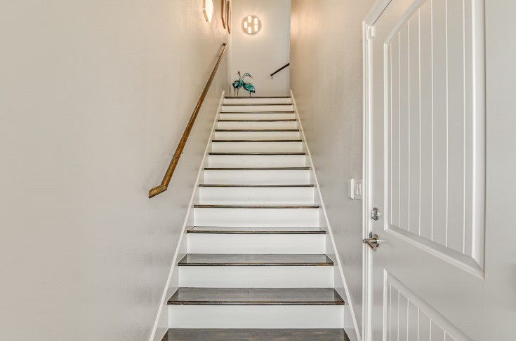 Elegant entry staircase in a fully furnished home at 1013 10th A, offering a warm welcome. Elegant entry staircase in a fully furnished home at 1013 10th A, offering a warm welcome.