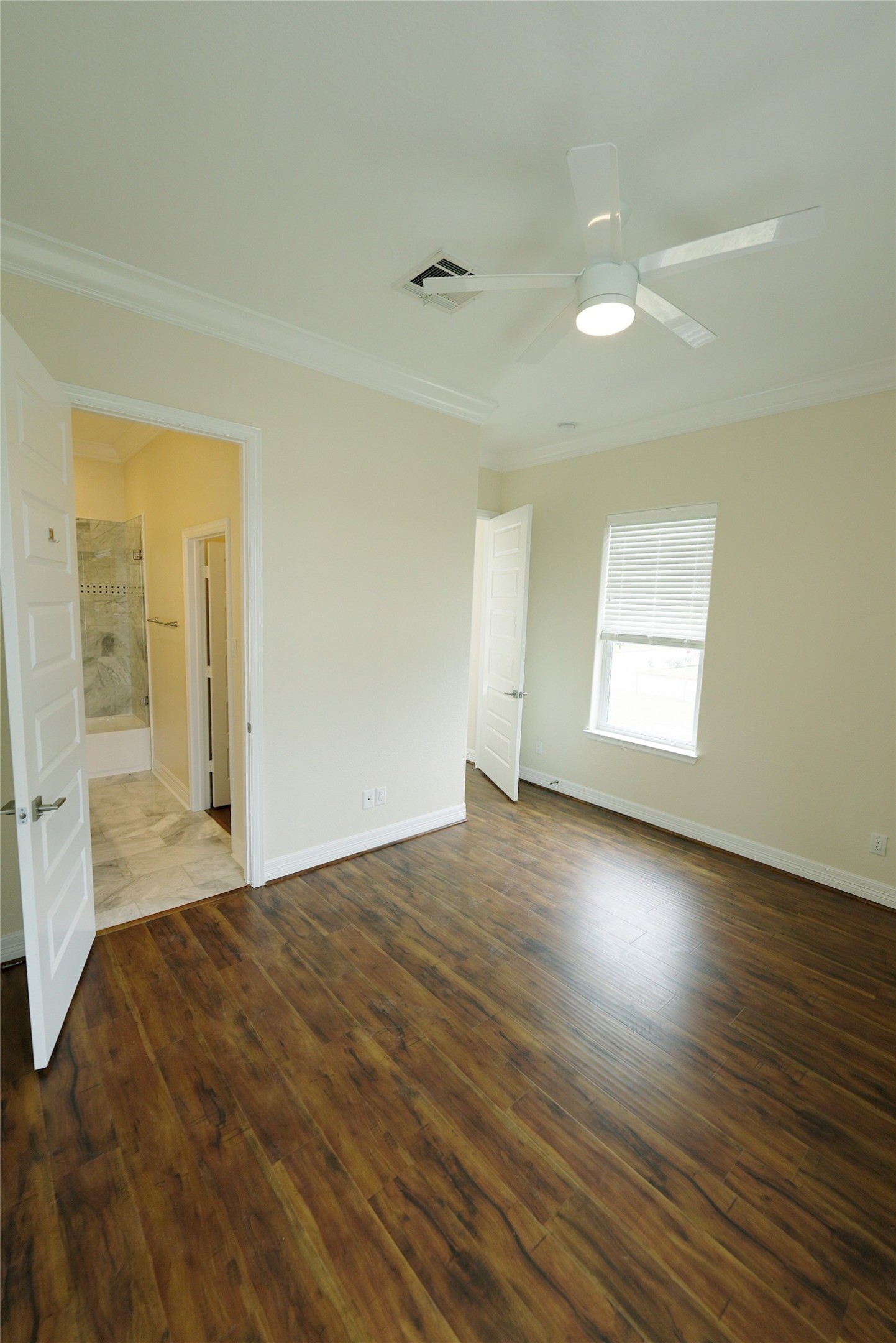 Elegant guest bedroom featuring stunning hardwood floors. Currently tenant-occupied.