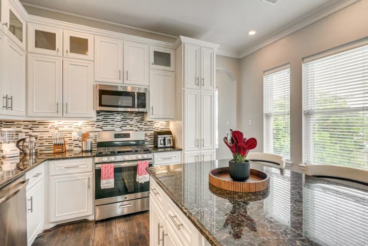 Elegant and fully furnished kitchen at 1013 10th A, featuring modern appliances, chic cabinetry, and ample natural light.