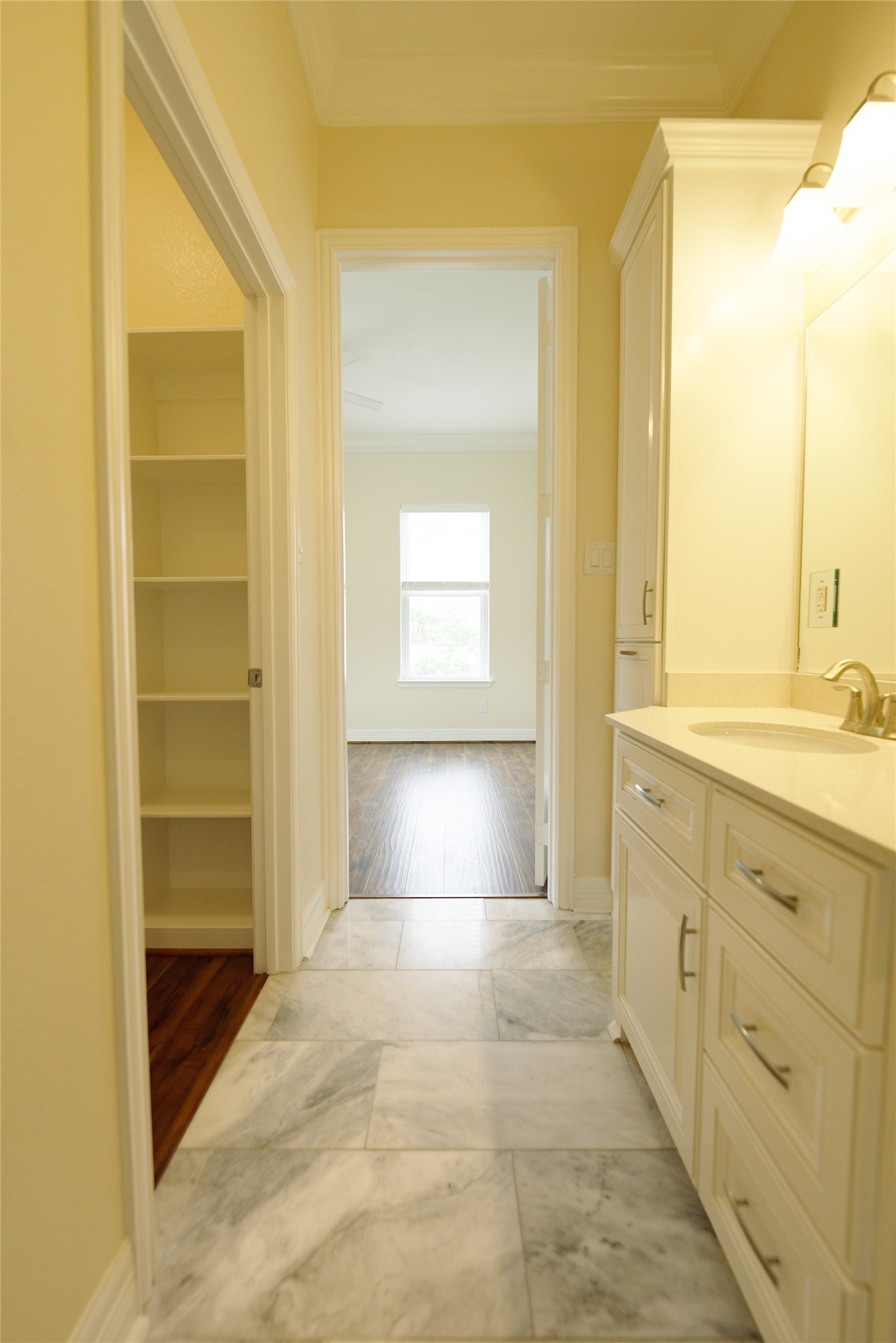 Elegant guest bathroom featuring luxurious marble floors and a spacious walk-in closet.