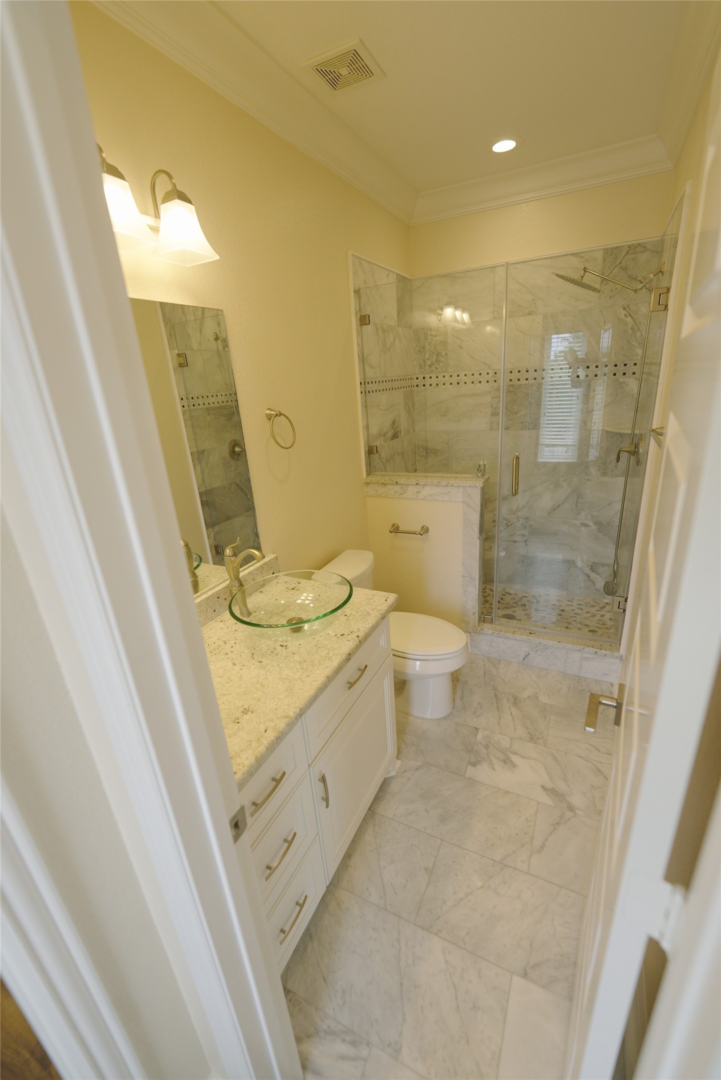 Luxurious guest bathroom featuring elegant marble finishes. Currently tenant occupied.