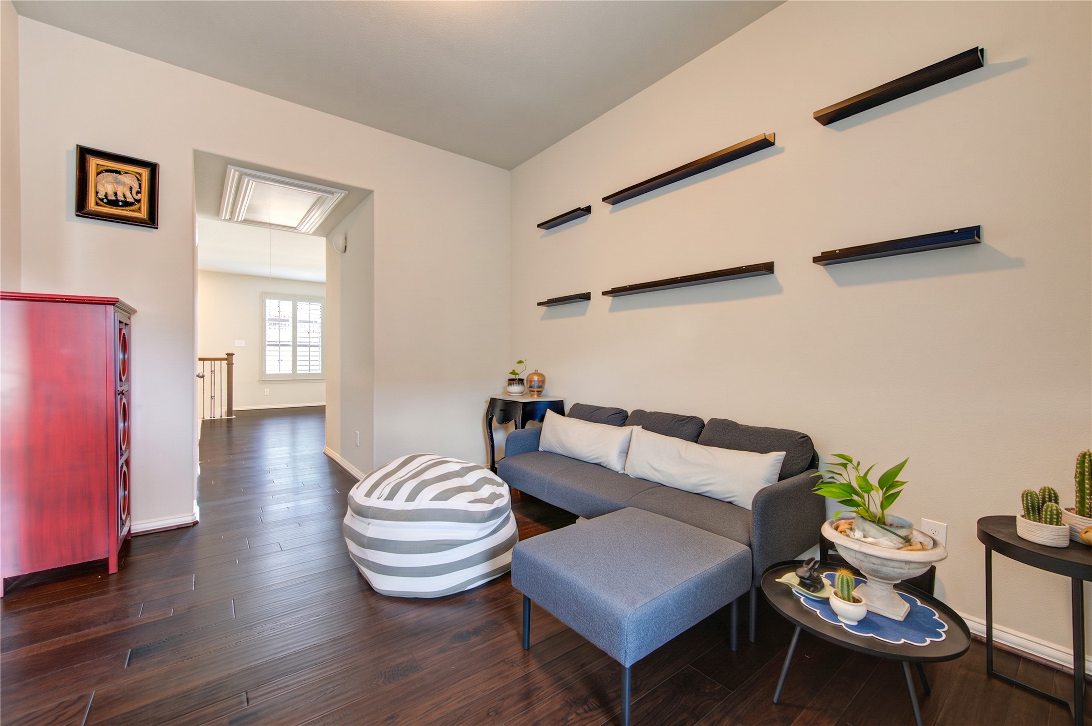 An additional office or sitting area is conveniently located just off the open game room, offering a versatile space for working from home, studying, or creating a cozy retreat.