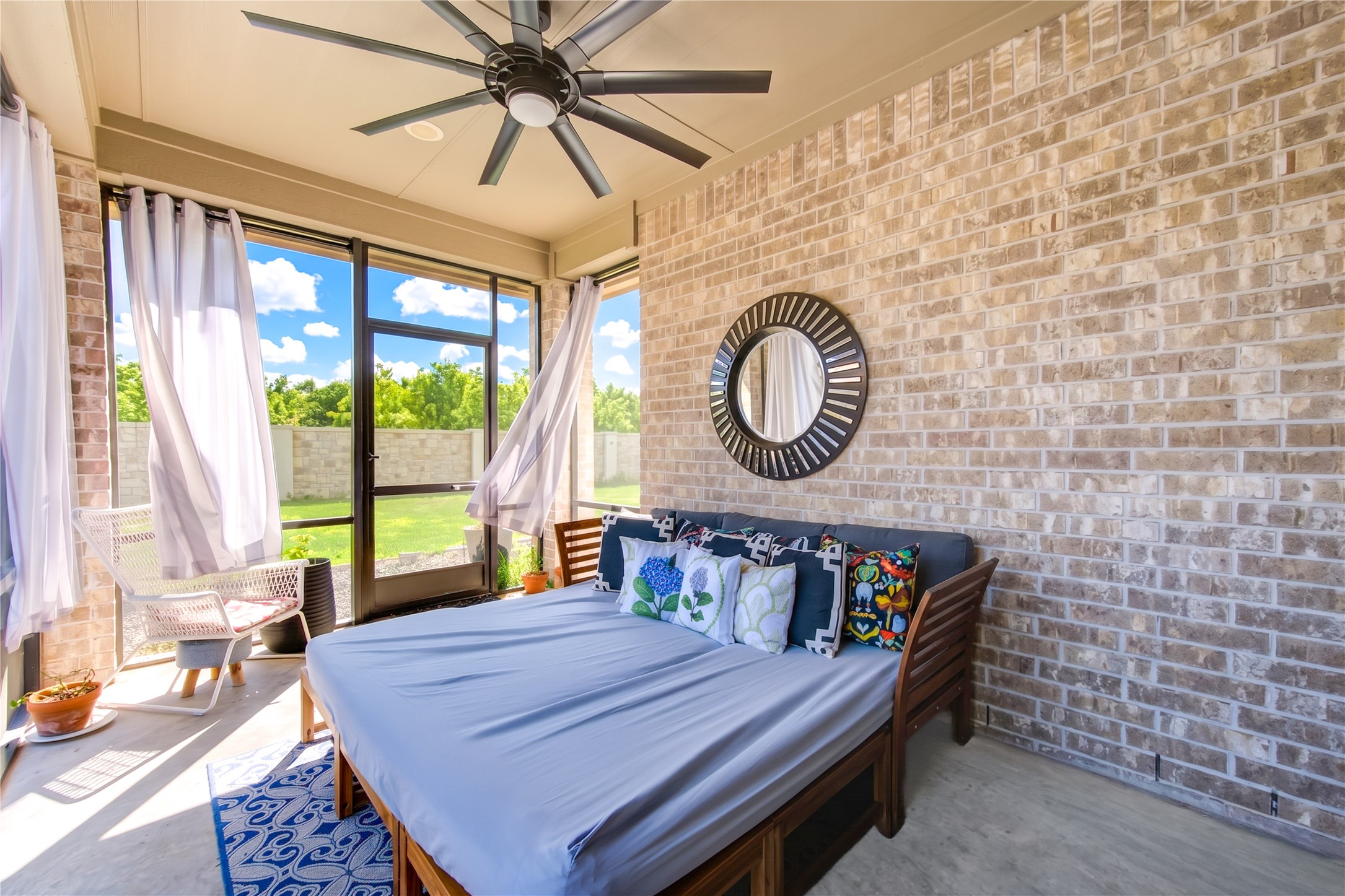 A screened-in, covered back patio offers the perfect place to enjoy your backyard day or night, rain or shine.