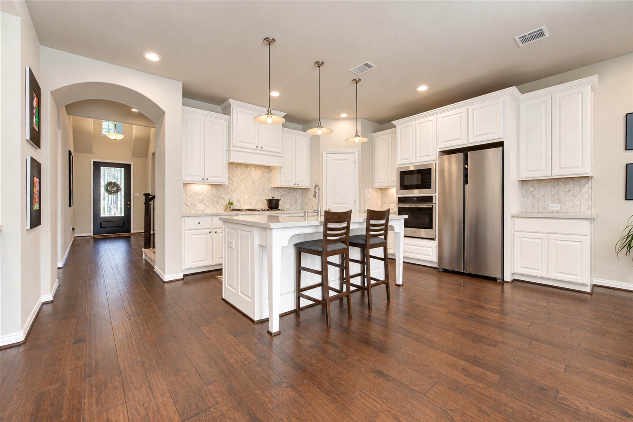 The open-concept floor plan is ideal for entertaining, with the kitchen flowing seamlessly into the family room and breakfast area to create a welcoming space for gathering with family and friends.