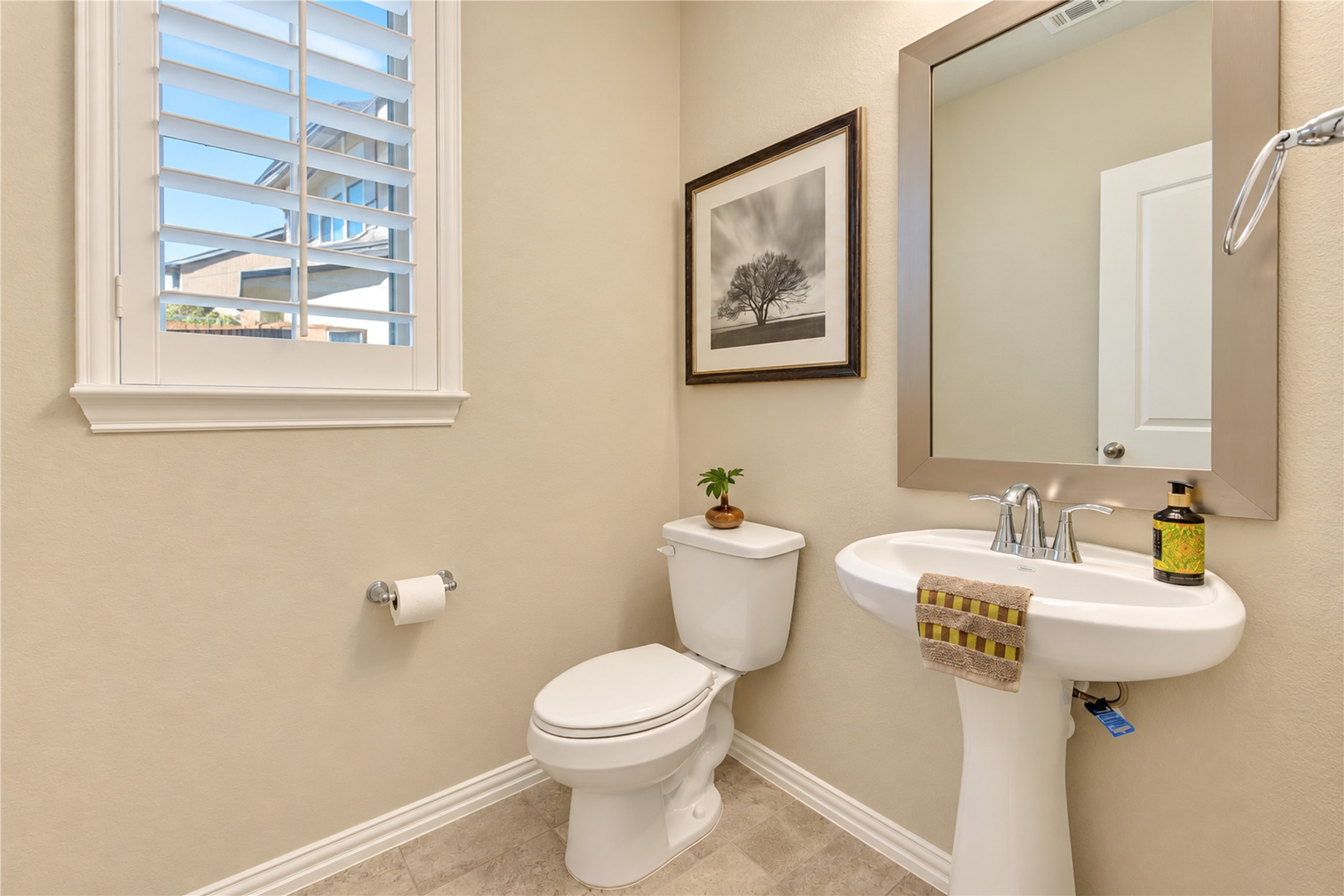 The conveniently located half bath offers easy access for guests, adding comfort and convenience when entertaining.