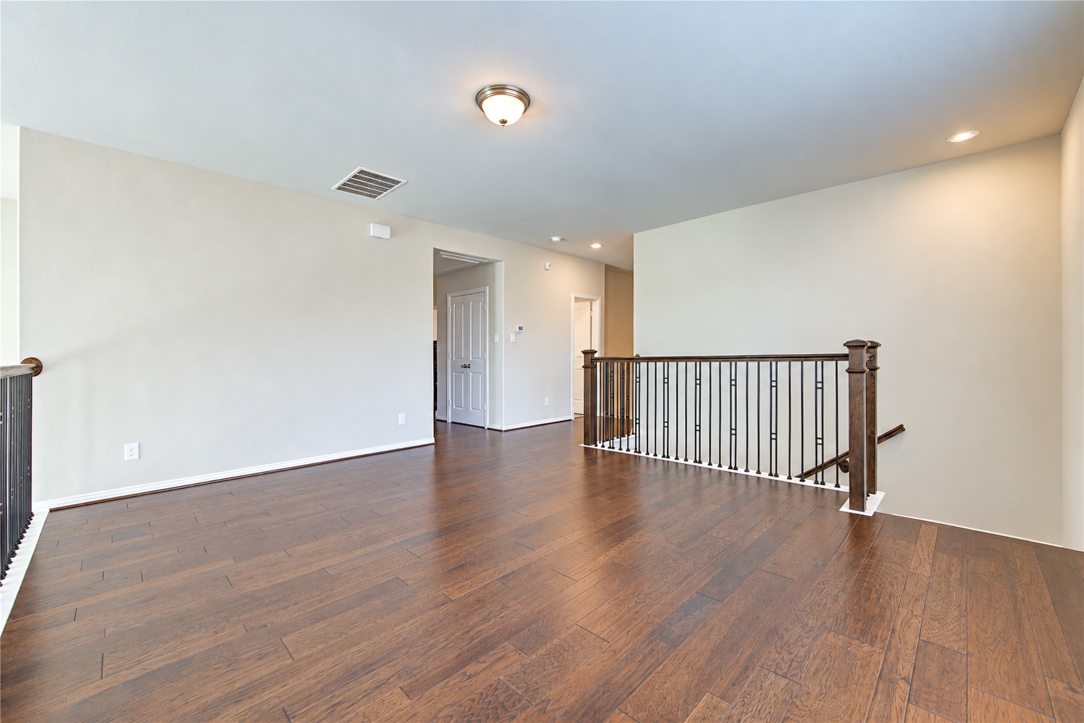 The upstairs game room overlooks the homes dramatic two-story living areas, creating an open, airy feel while allowing abundant natural light to flow throughout the space.