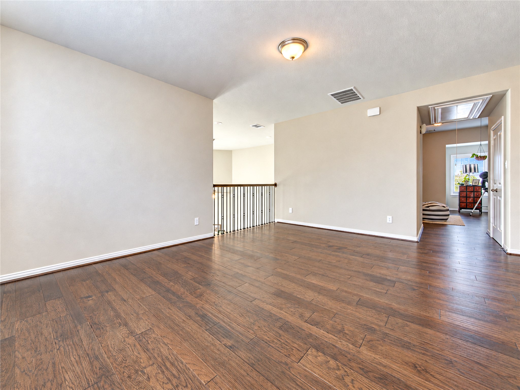 The upstairs game room overlooks the homes dramatic two-story living areas, creating an open, airy feel while allowing abundant natural light to flow throughout the space.