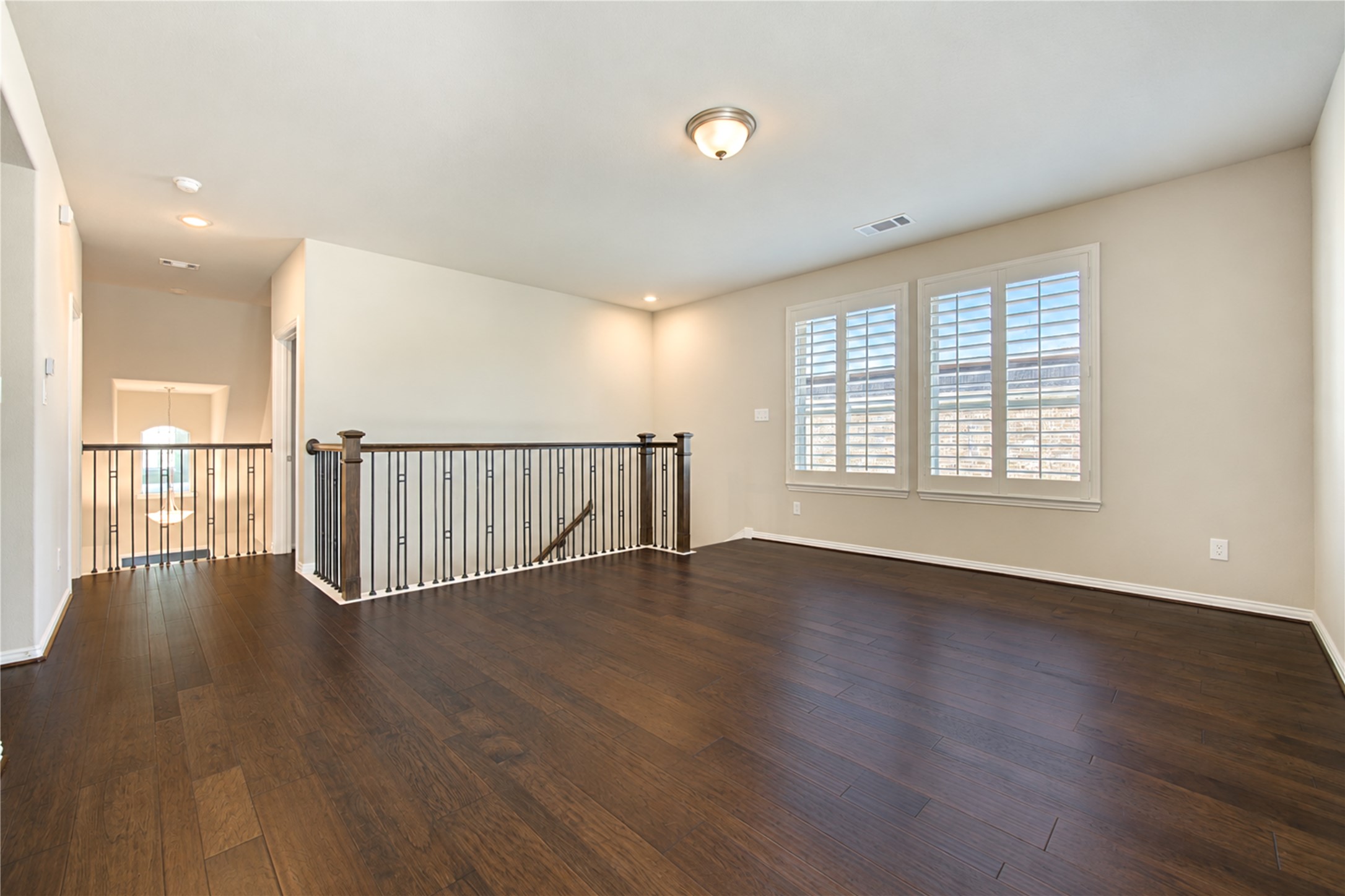 The upstairs game room overlooks the homes dramatic two-story living areas, creating an open, airy feel while allowing abundant natural light to flow throughout the space.