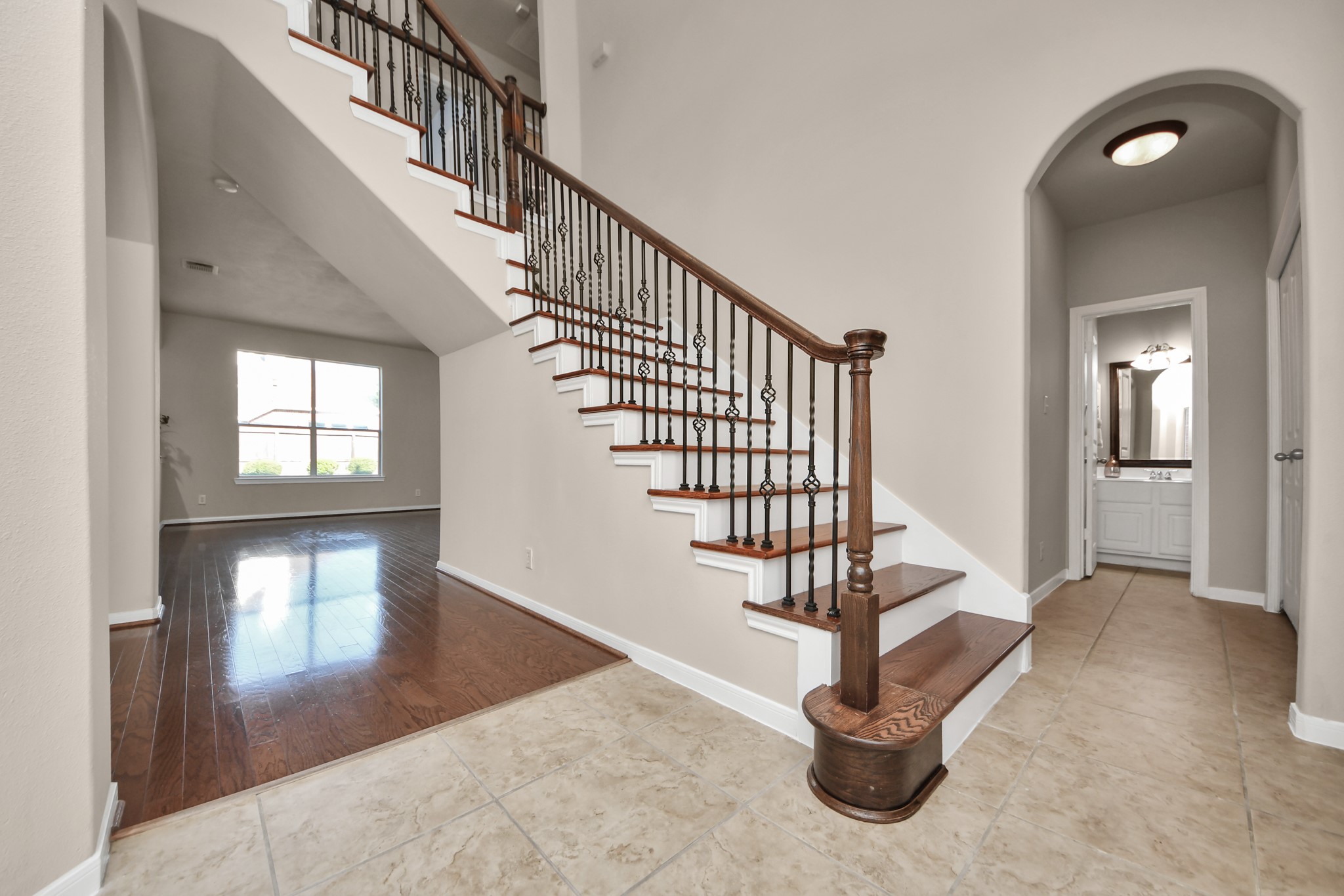 To the right of the staircase you will find the laundry room, a generous storage closet, garage access, a bedroom and full bath.