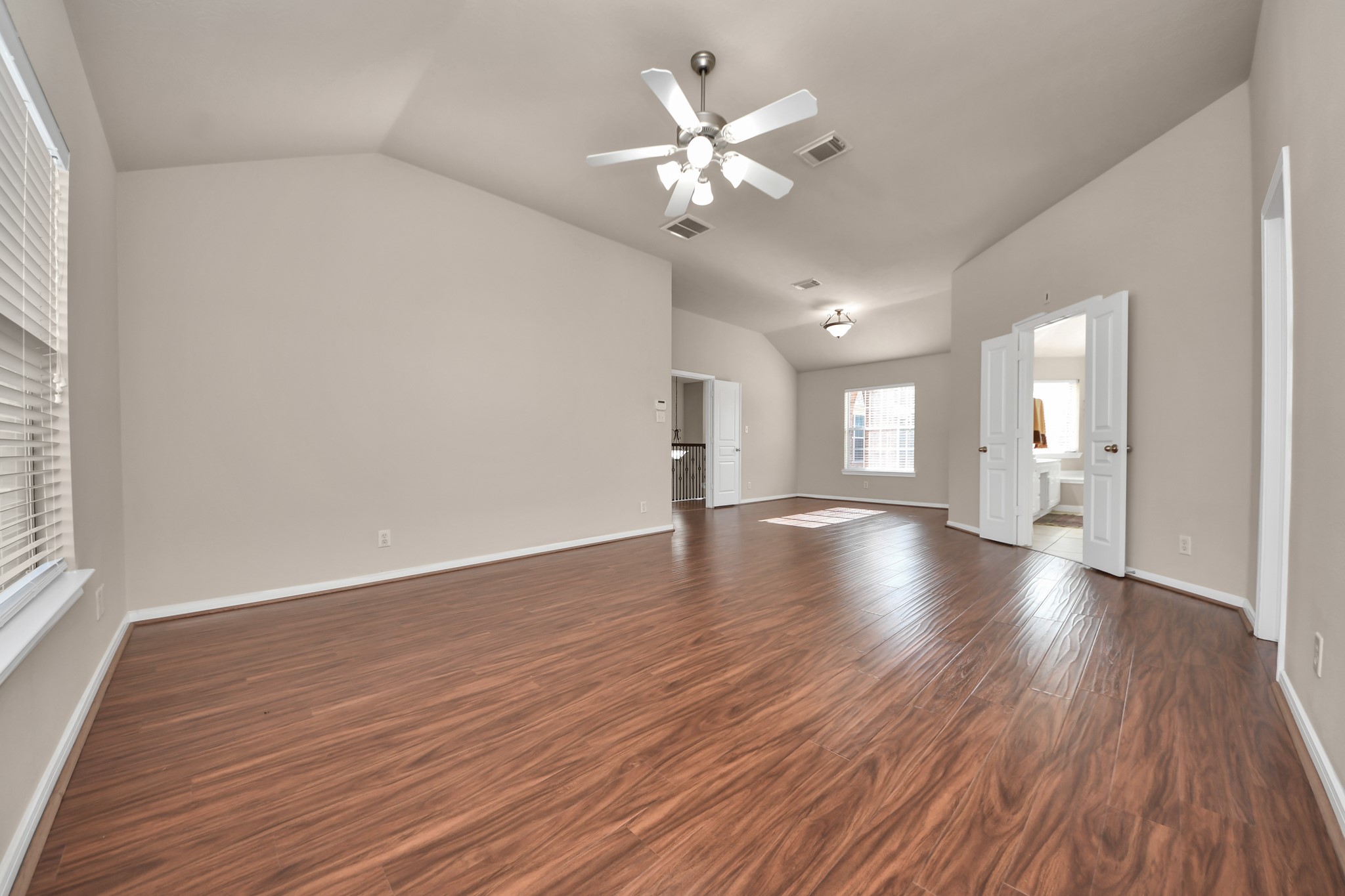 The spacious primary bedroom includes two walk-in closets and is positioned away from the other bedrooms to provide added privacy.