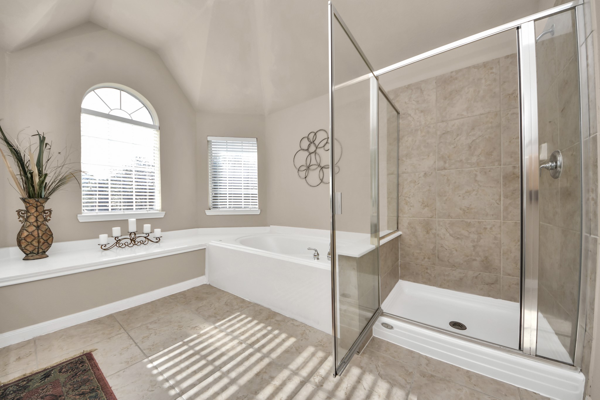 The primary bathroom offers a spa-like retreat, featuring a spacious walk-in shower and a luxurious soaking tub.