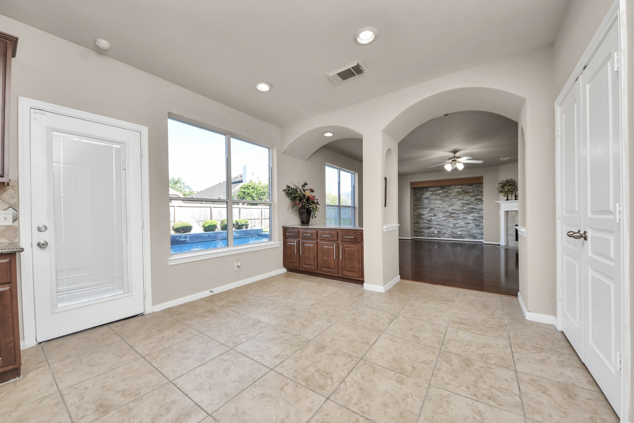 Custom cabinetry provides ample storage that extends beyond the kitchen, creating an ideal environment for culinary enthusiasts.