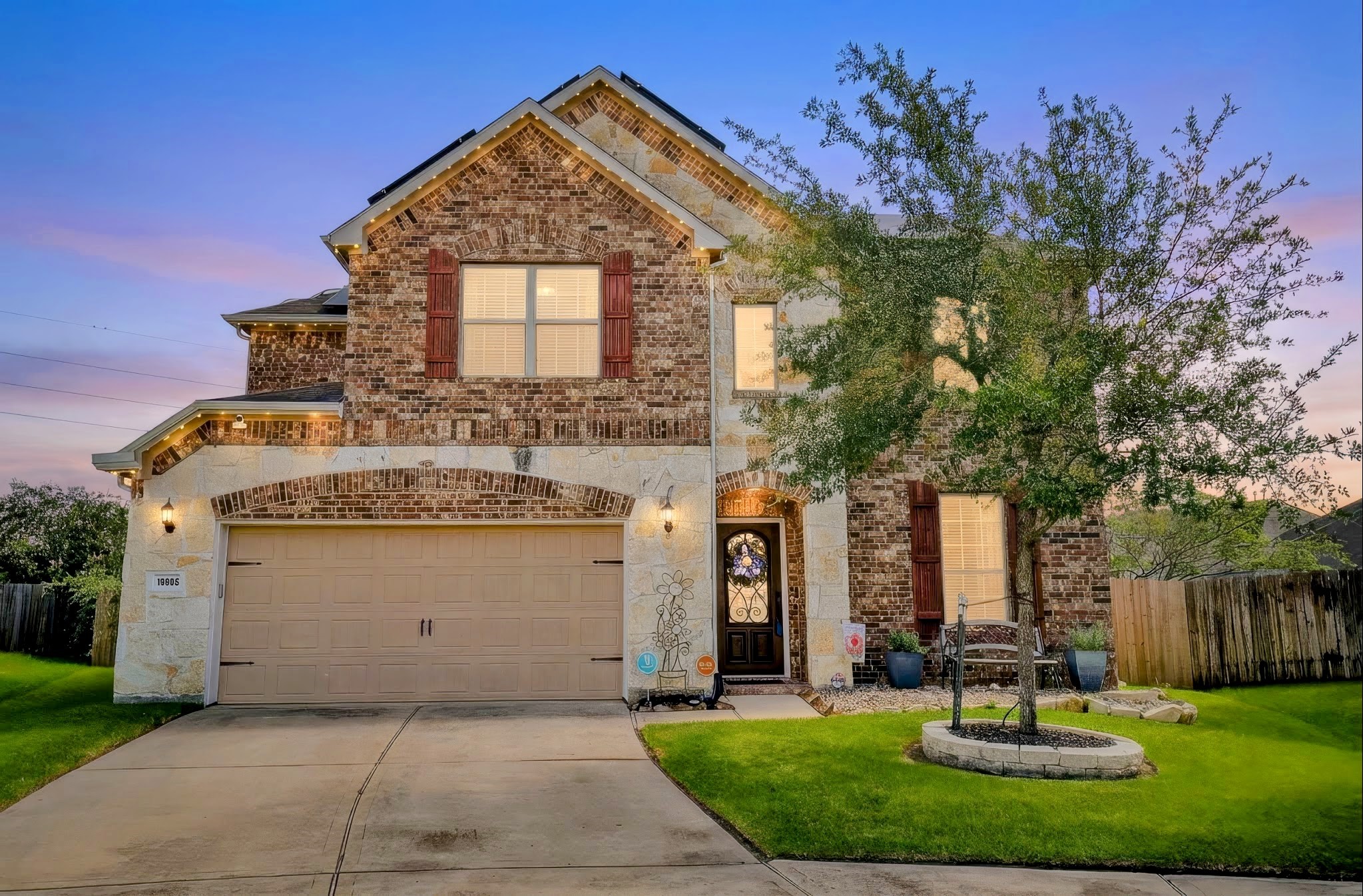 The front of the home with permanently installed Jellyfish lighting that are fully adjustable. The home also features an over-sized garage with a workspace.